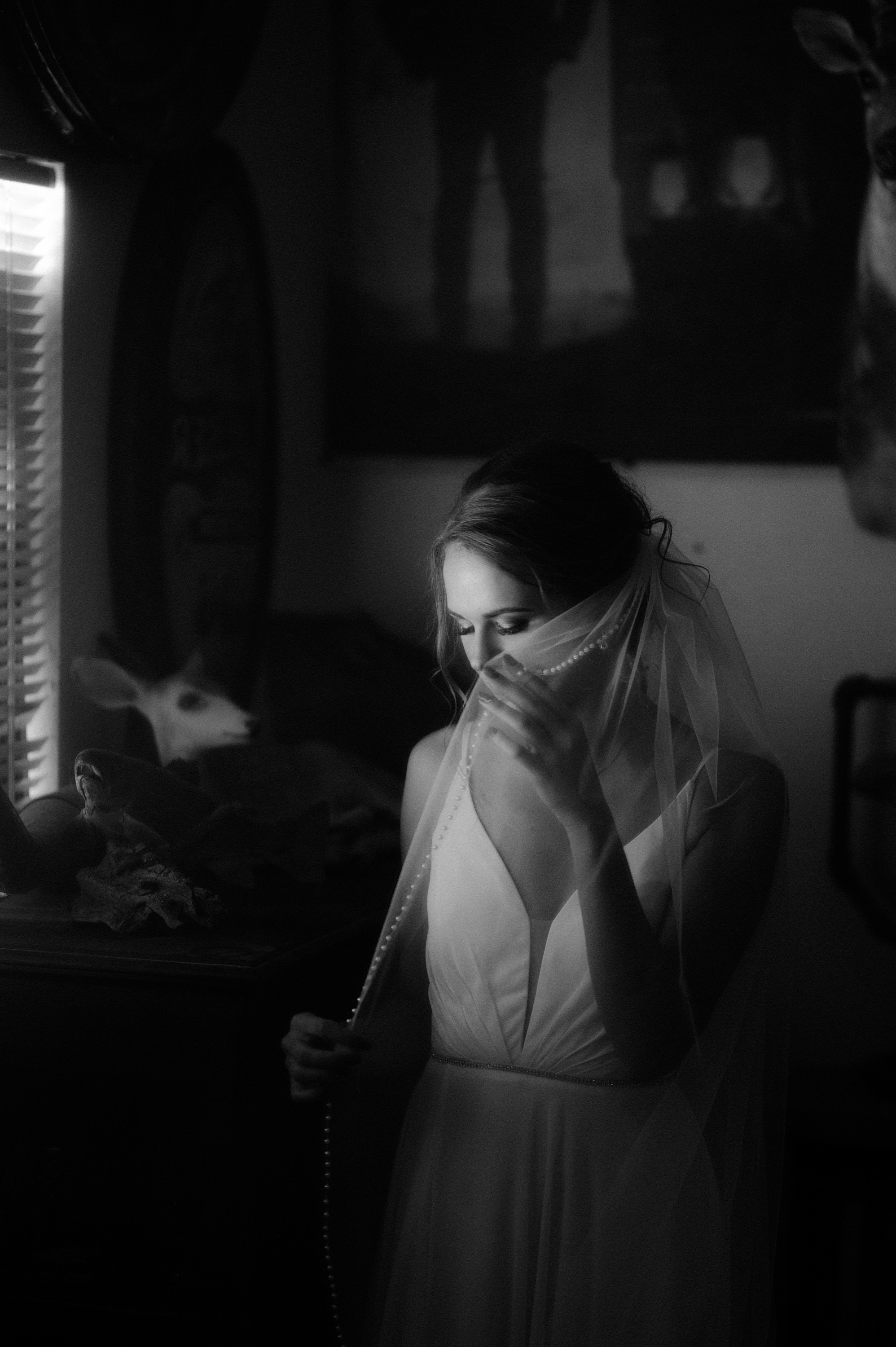 a woman in a wedding dress is looking at her phone
