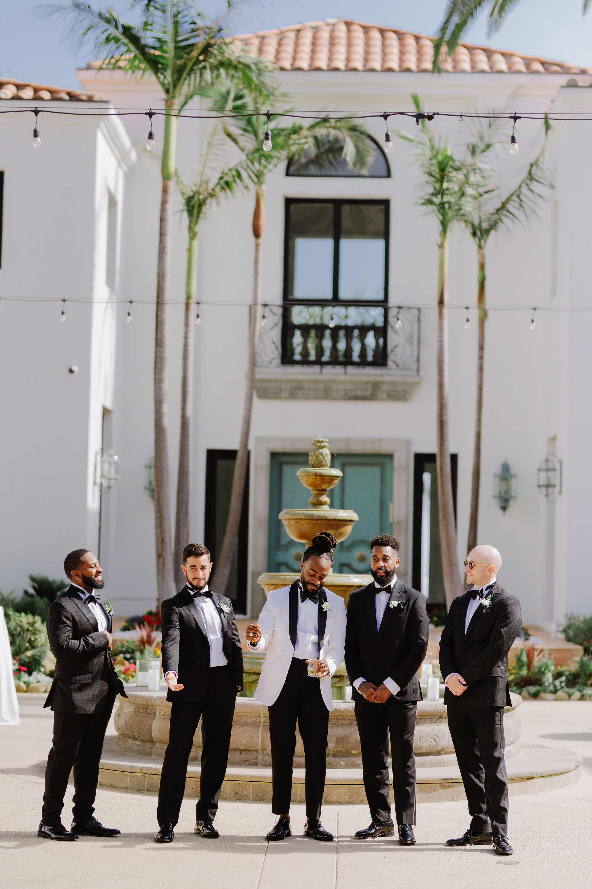 a group of men standing in front of a fountain