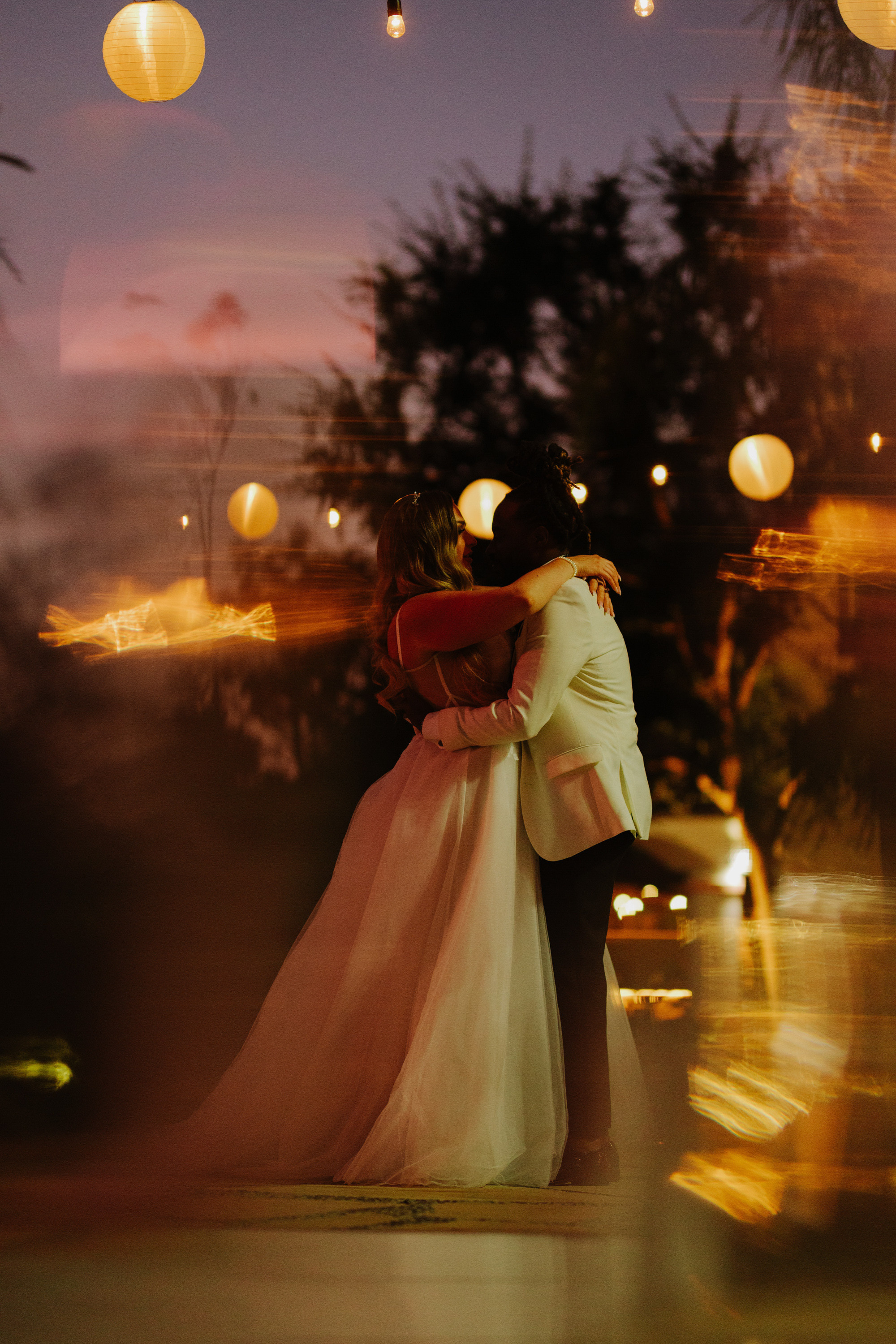 a couple is kissing in the street at night