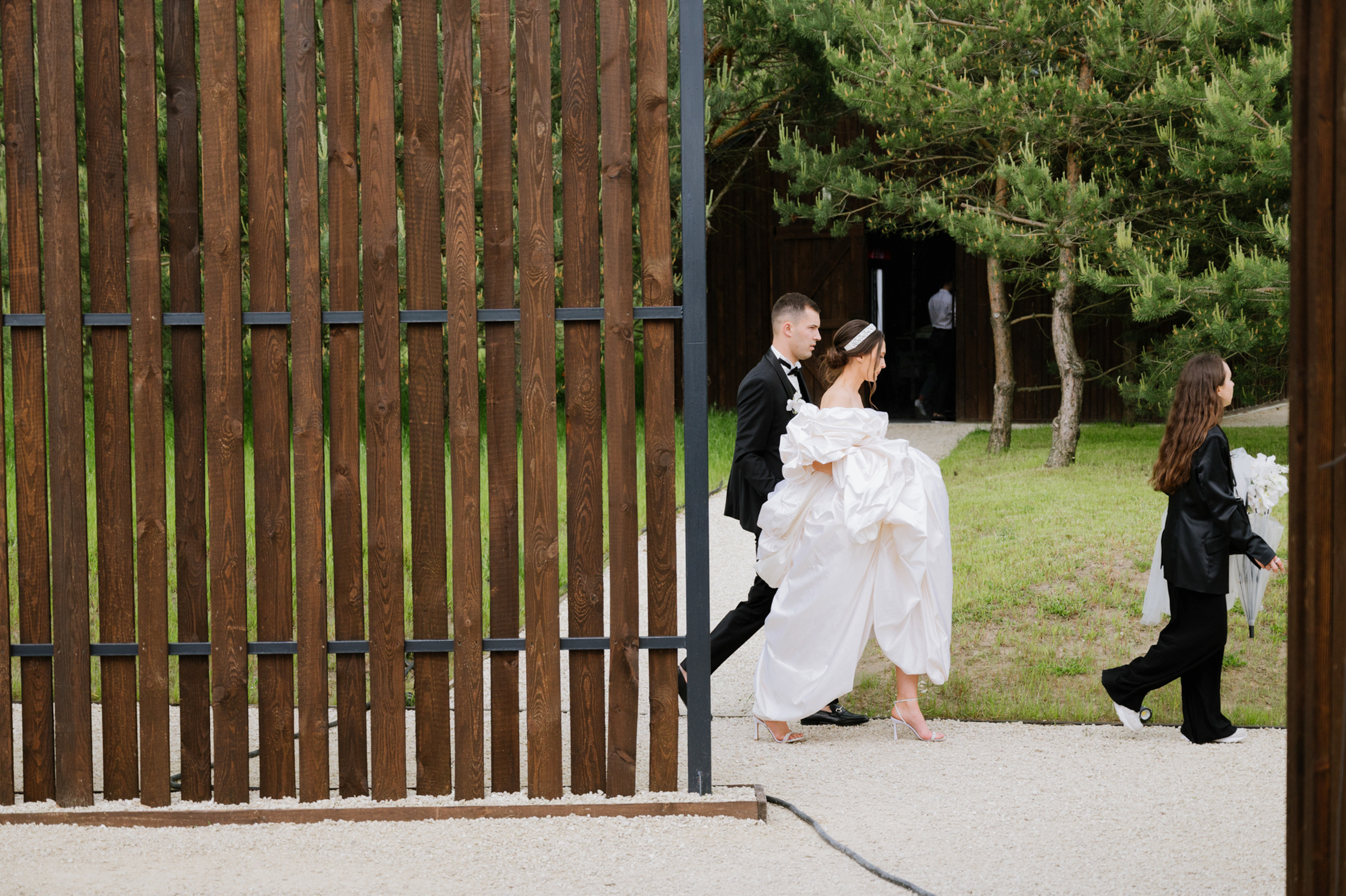 a couple of people that are standing in front of a fence