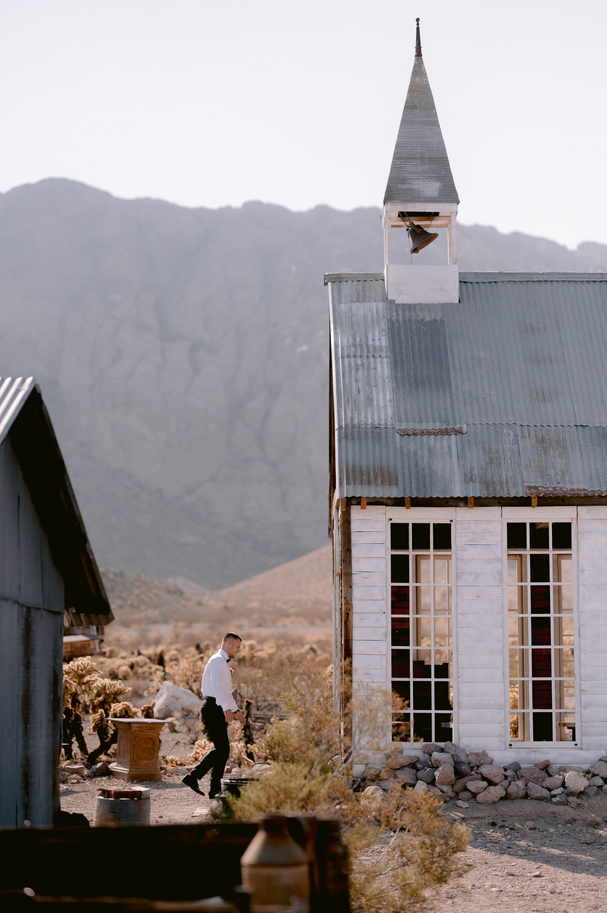a man is walking in front of a small building