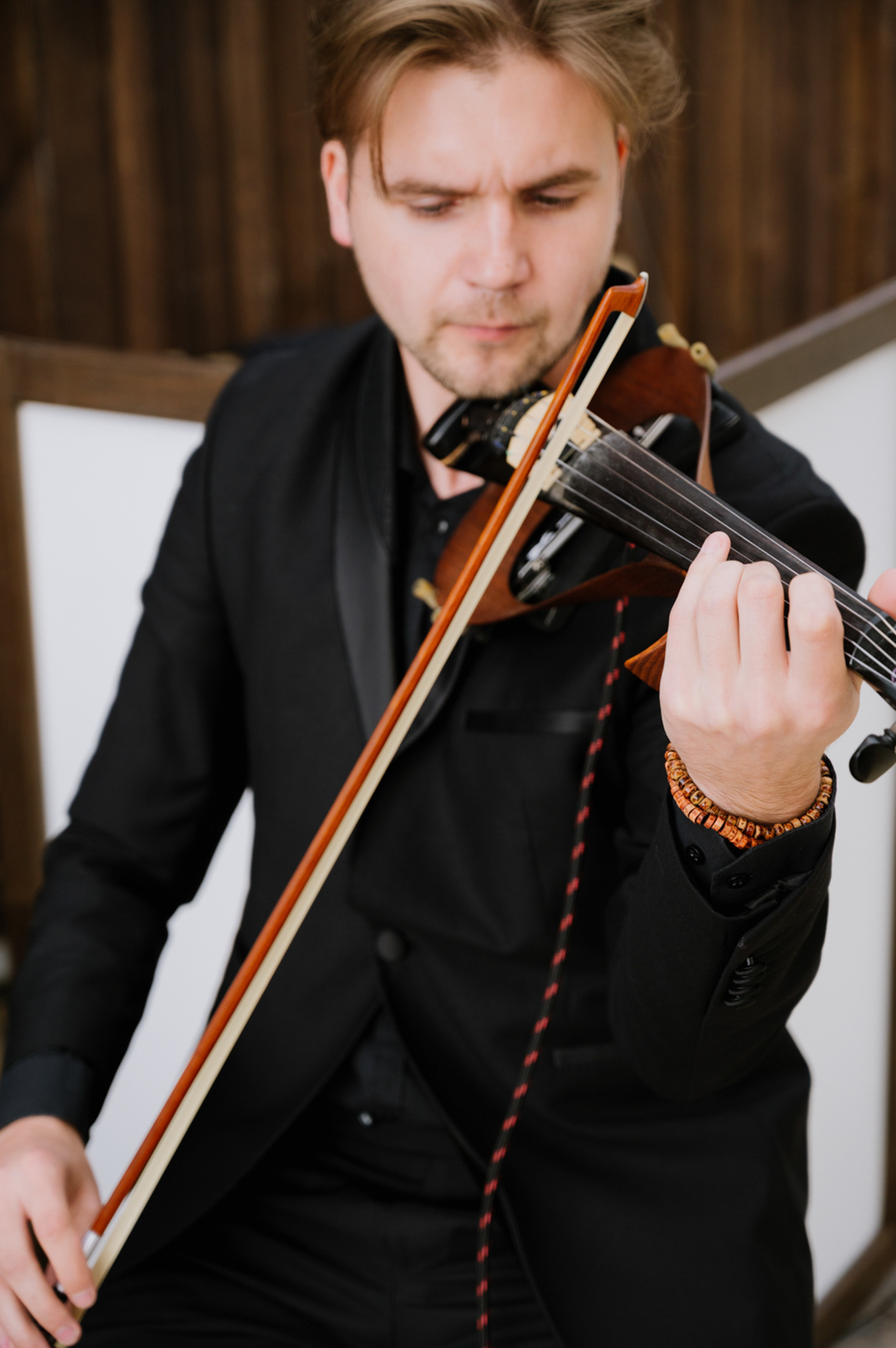 a man in a suit playing a violin