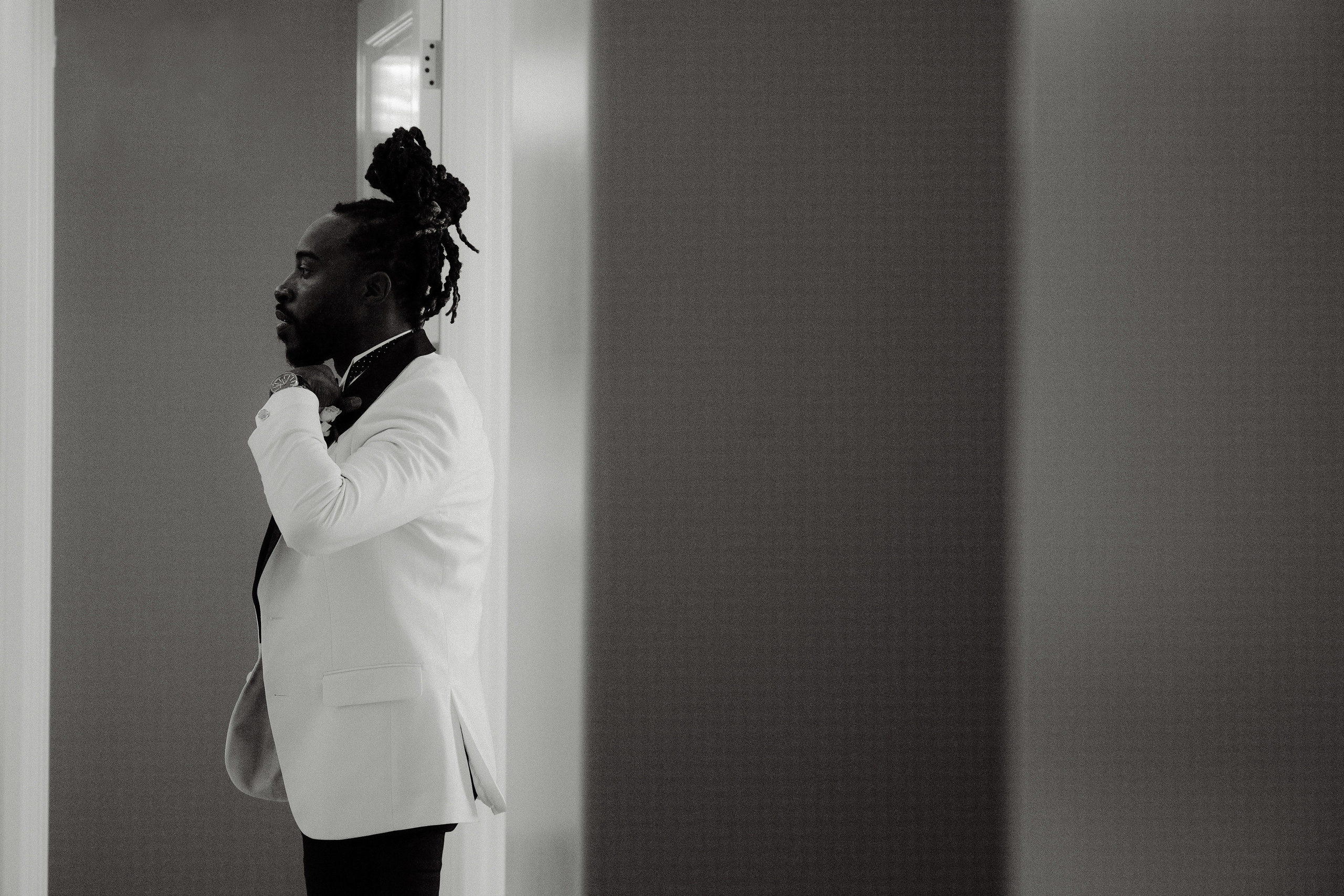 a man in a suit and tie standing in a room