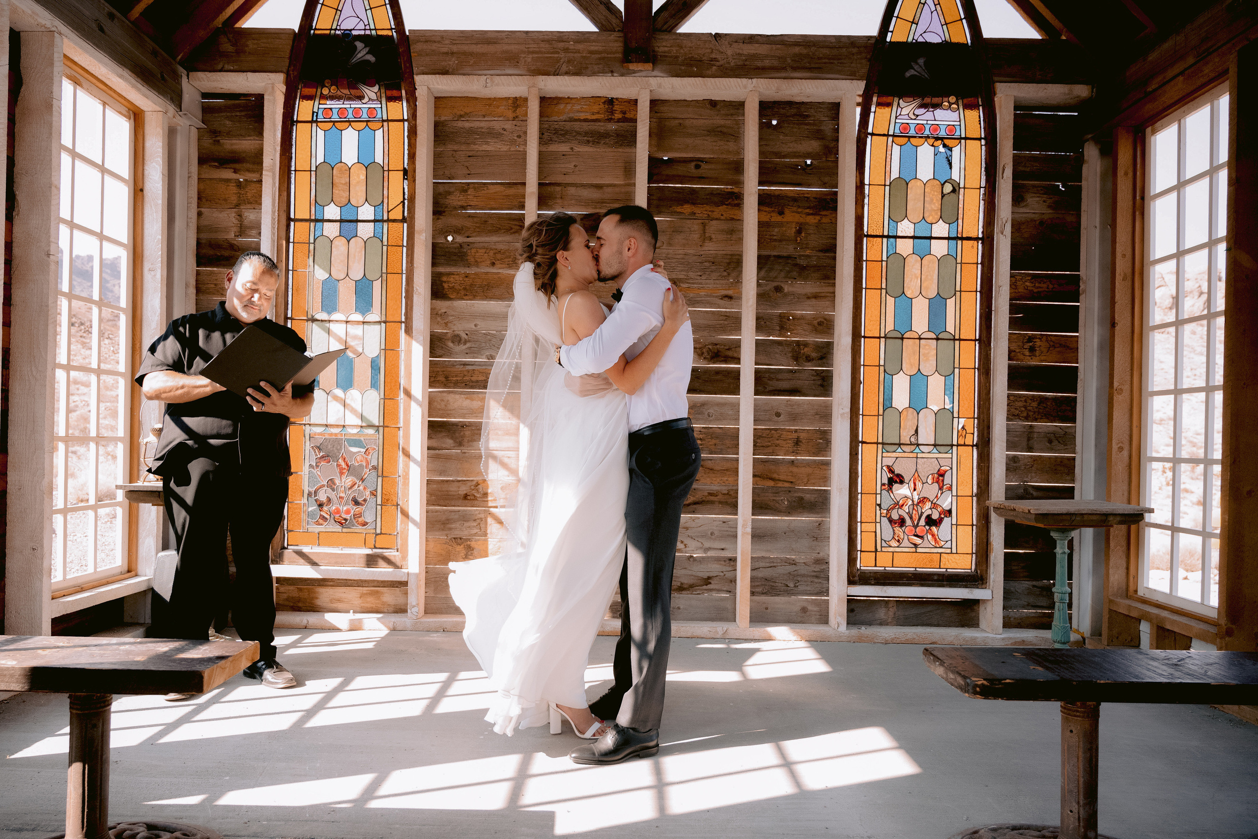 a bride and groom are standing in a church