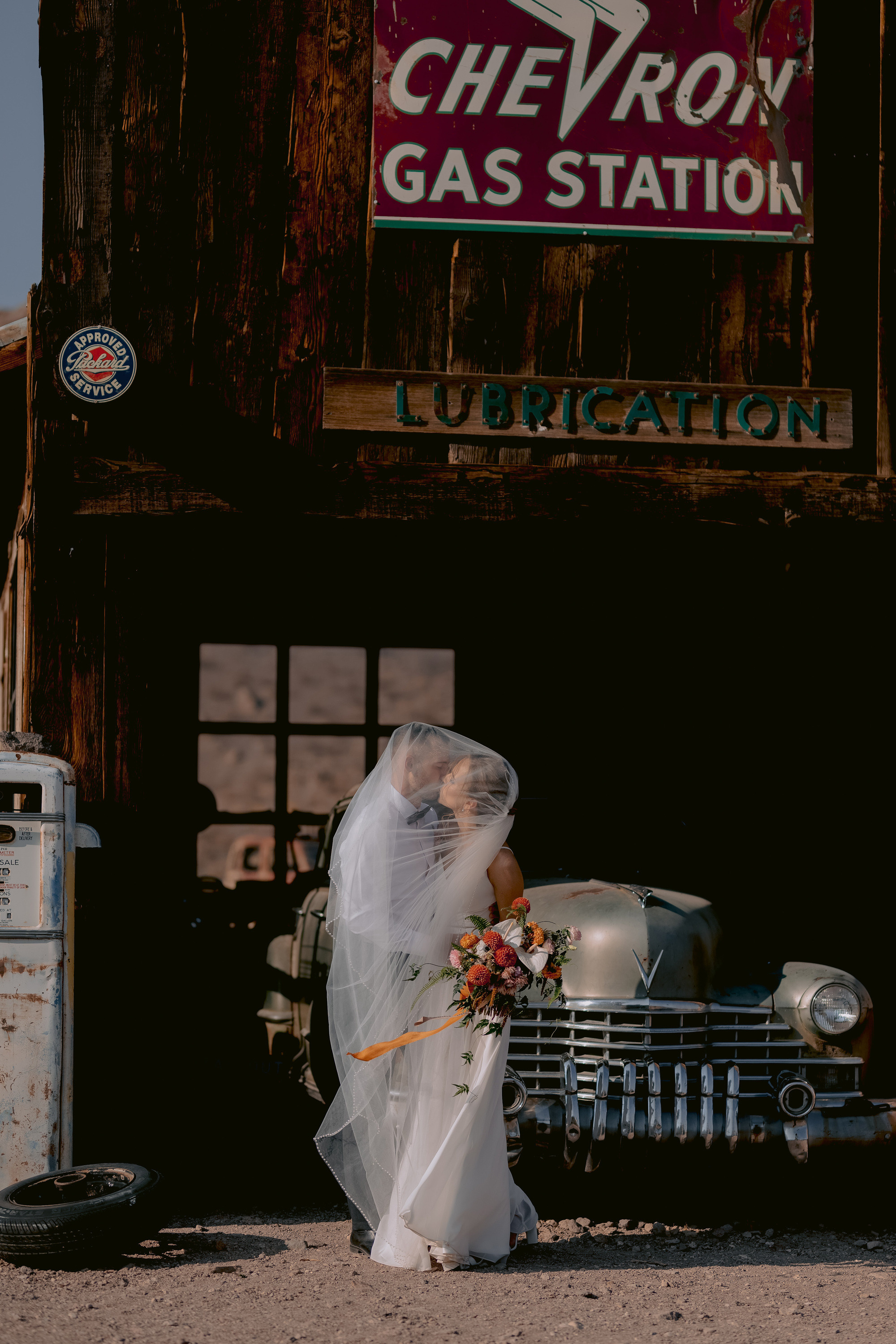 a bride is standing in front of a car