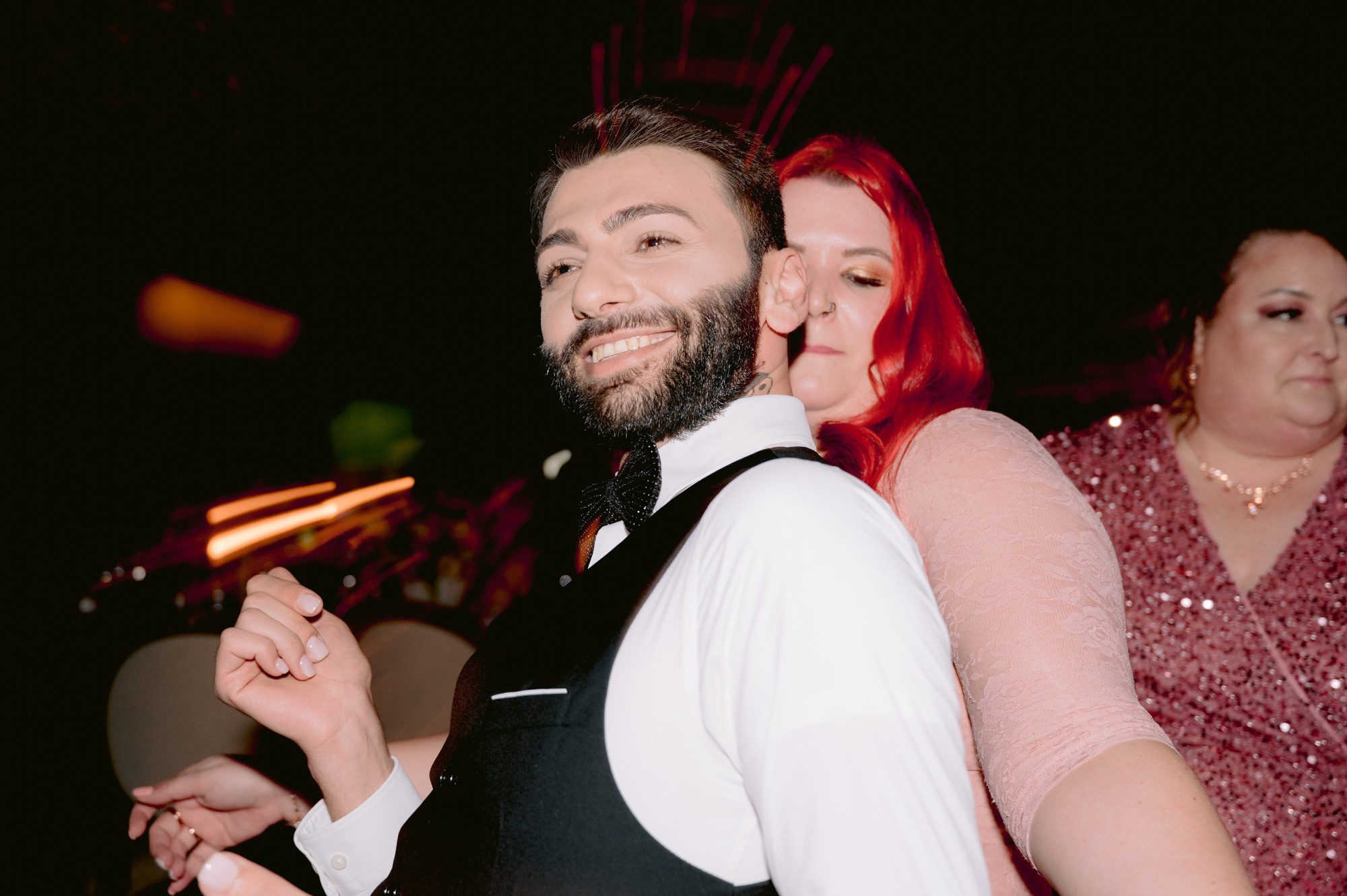 a man and woman dancing at a party