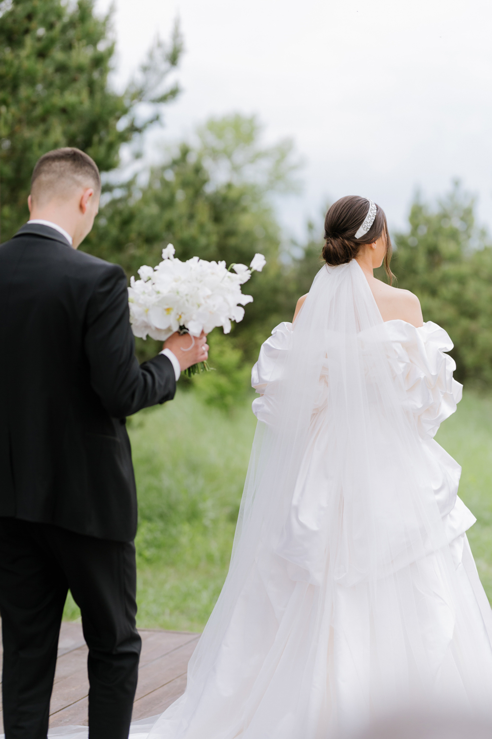 a bride and groom walking down the aisle