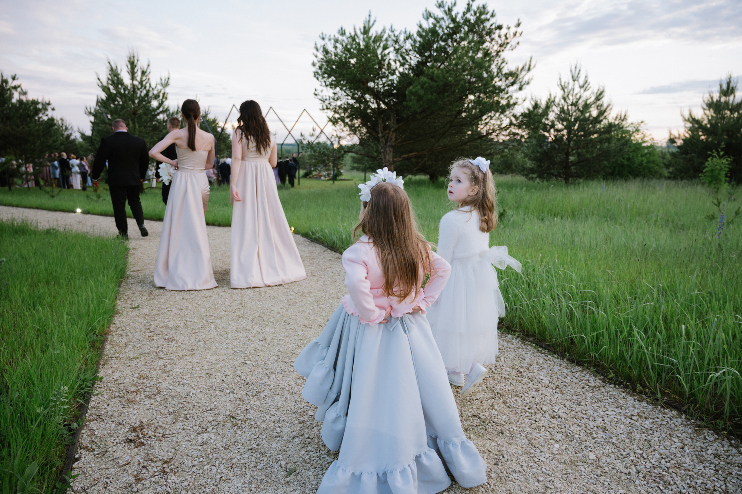 a group of young girls walking down a path