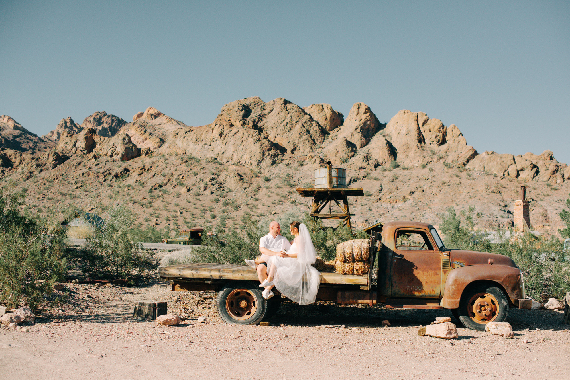 a woman sitting on the back of a truck