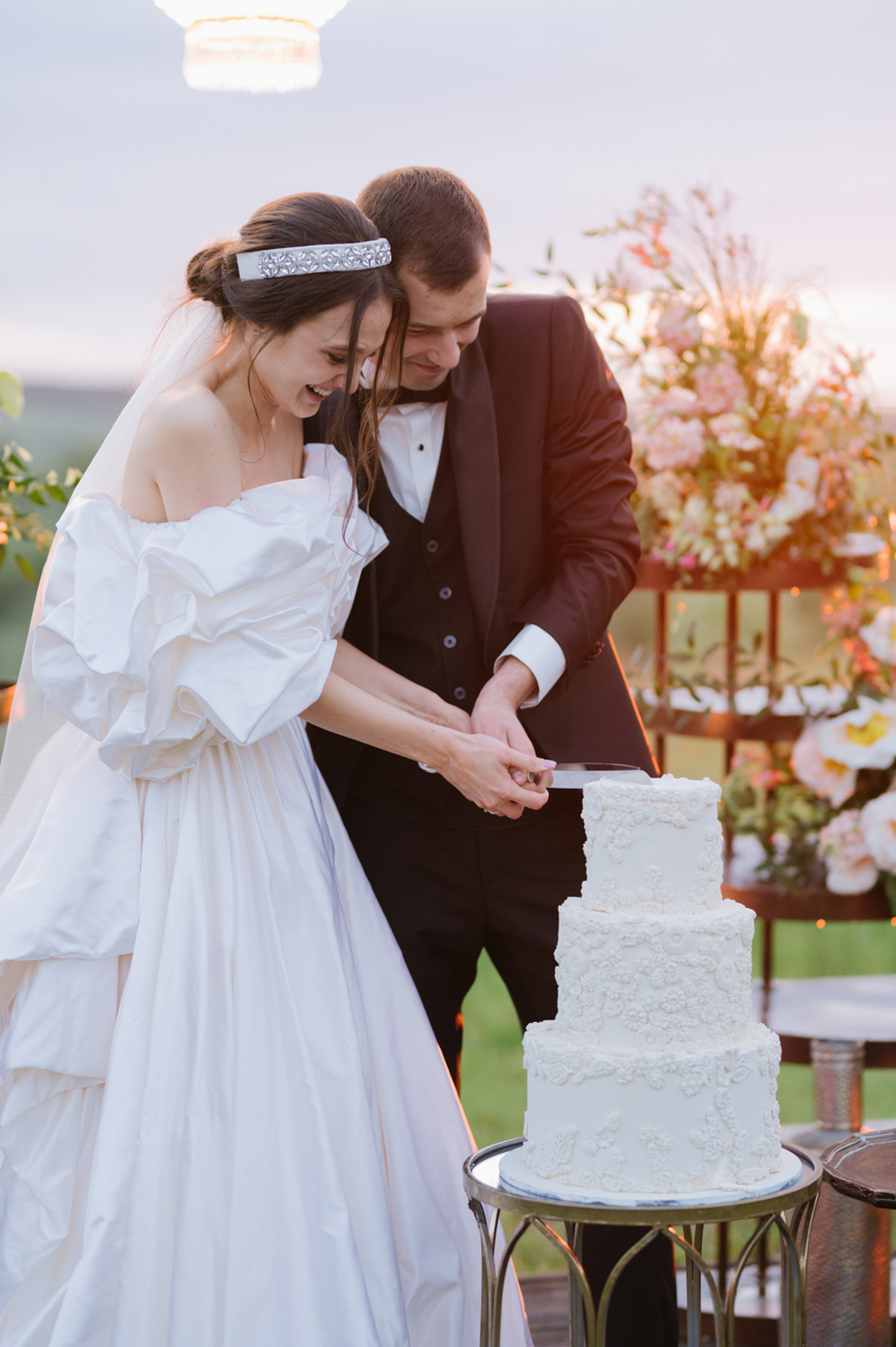 a bride and groom cutting a wedding cake