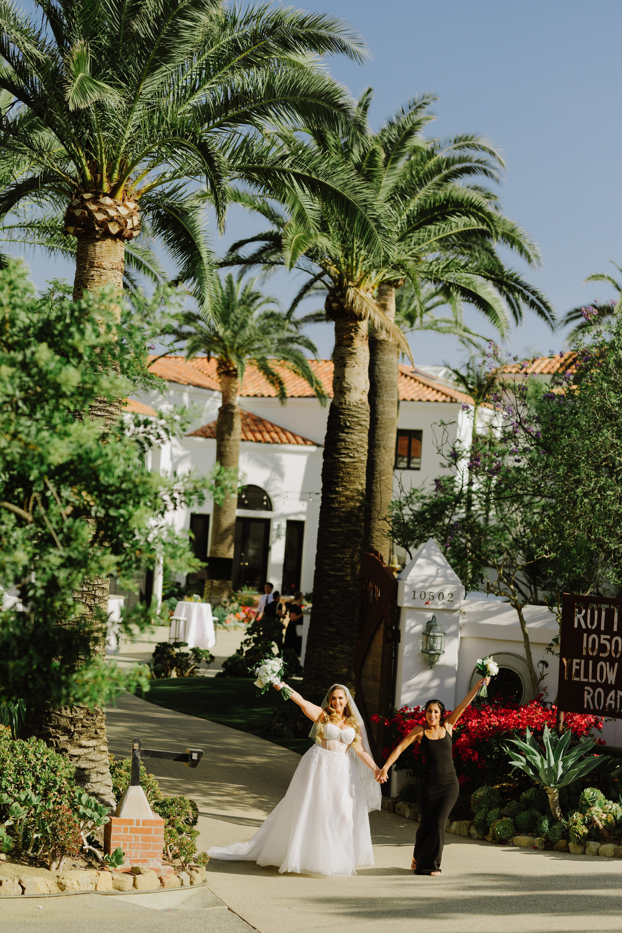 a bride and groom walking down a street