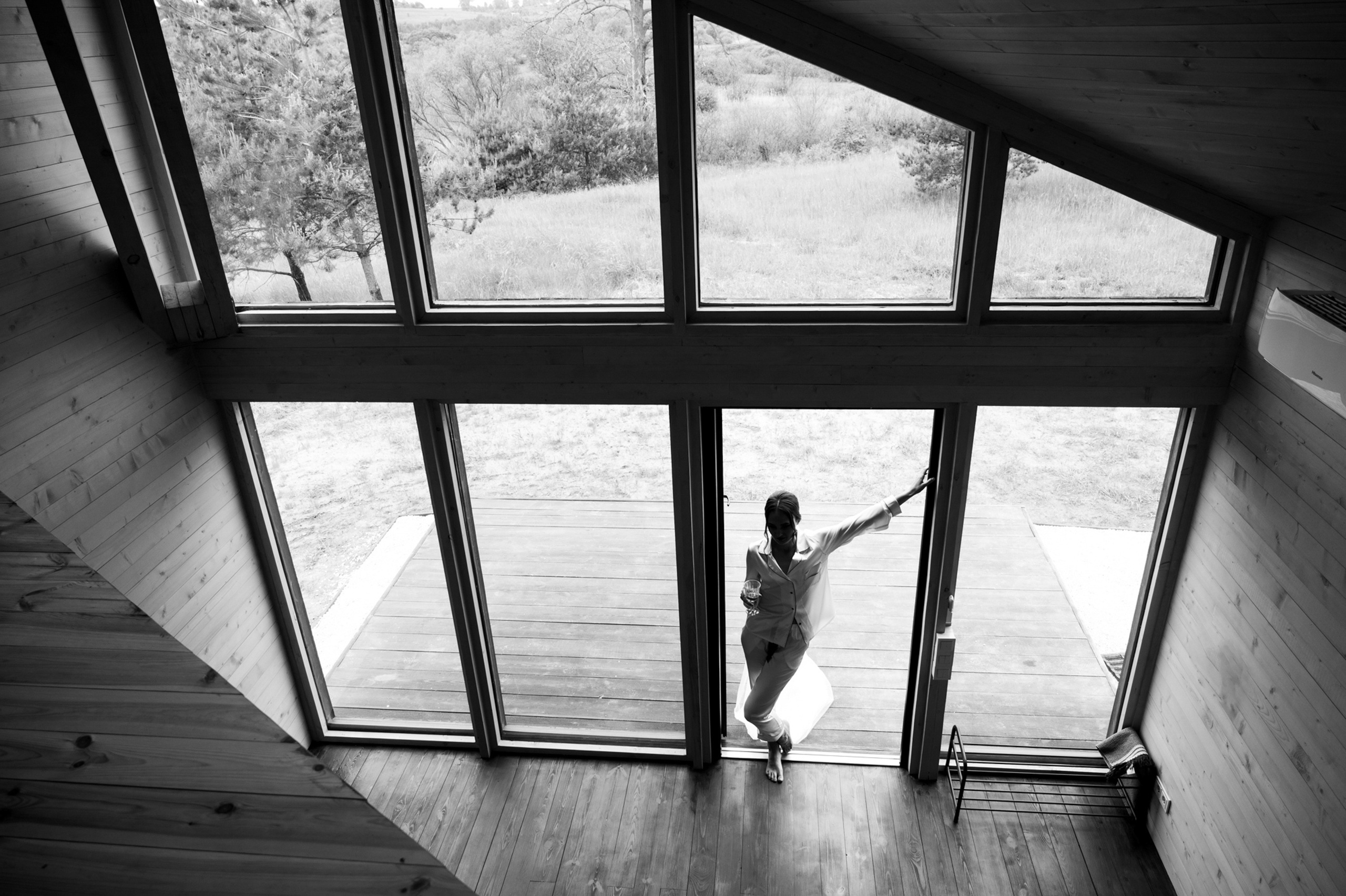 a woman standing in a room with a window