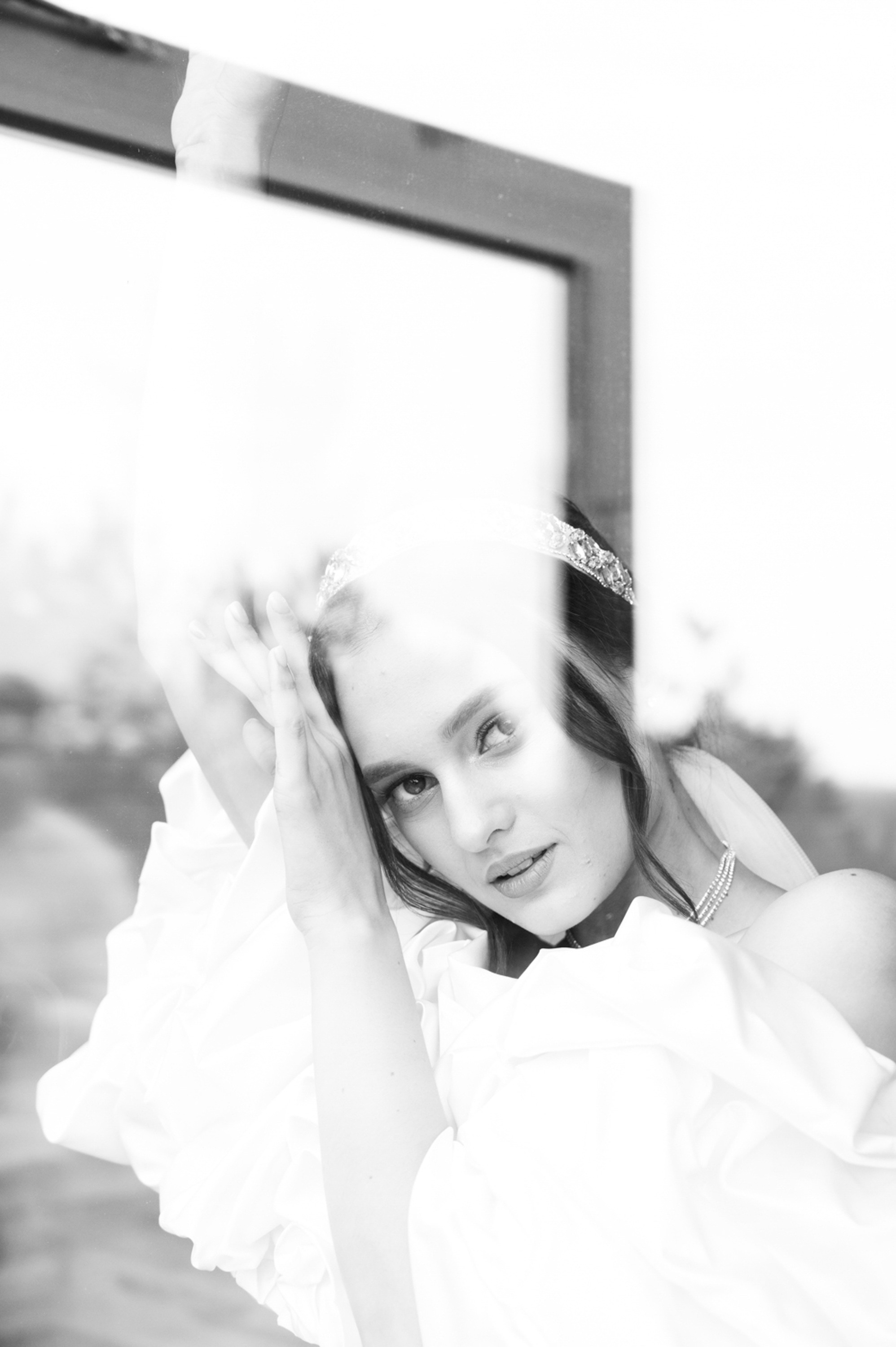 a woman in a white dress is looking at herself