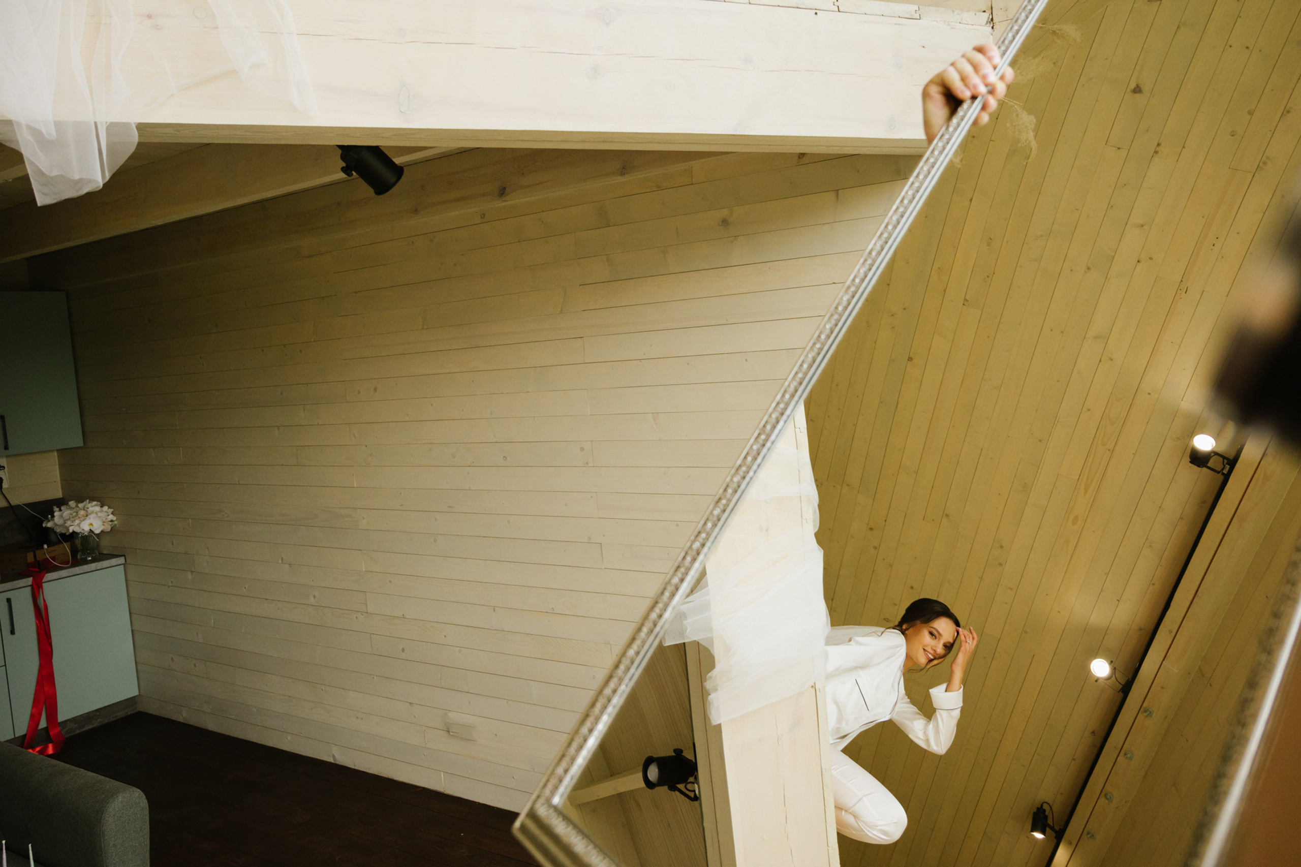 a man in a white suit is climbing up a ladder
