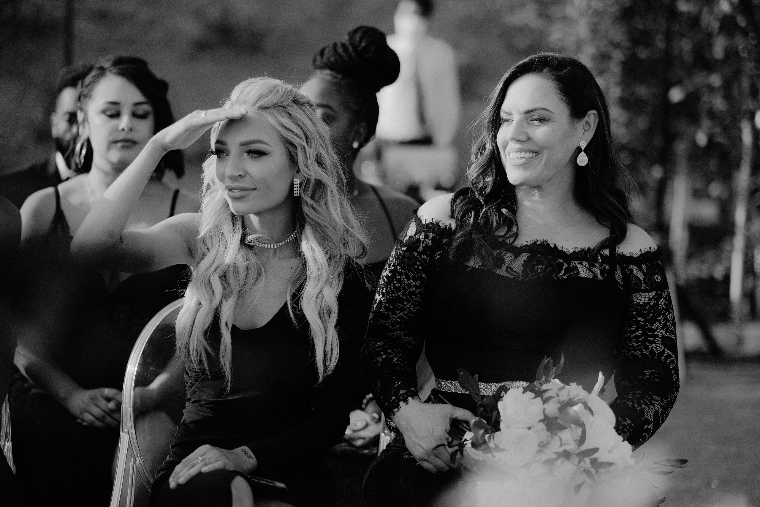 a bride and her bridesmaids walk down the aisle