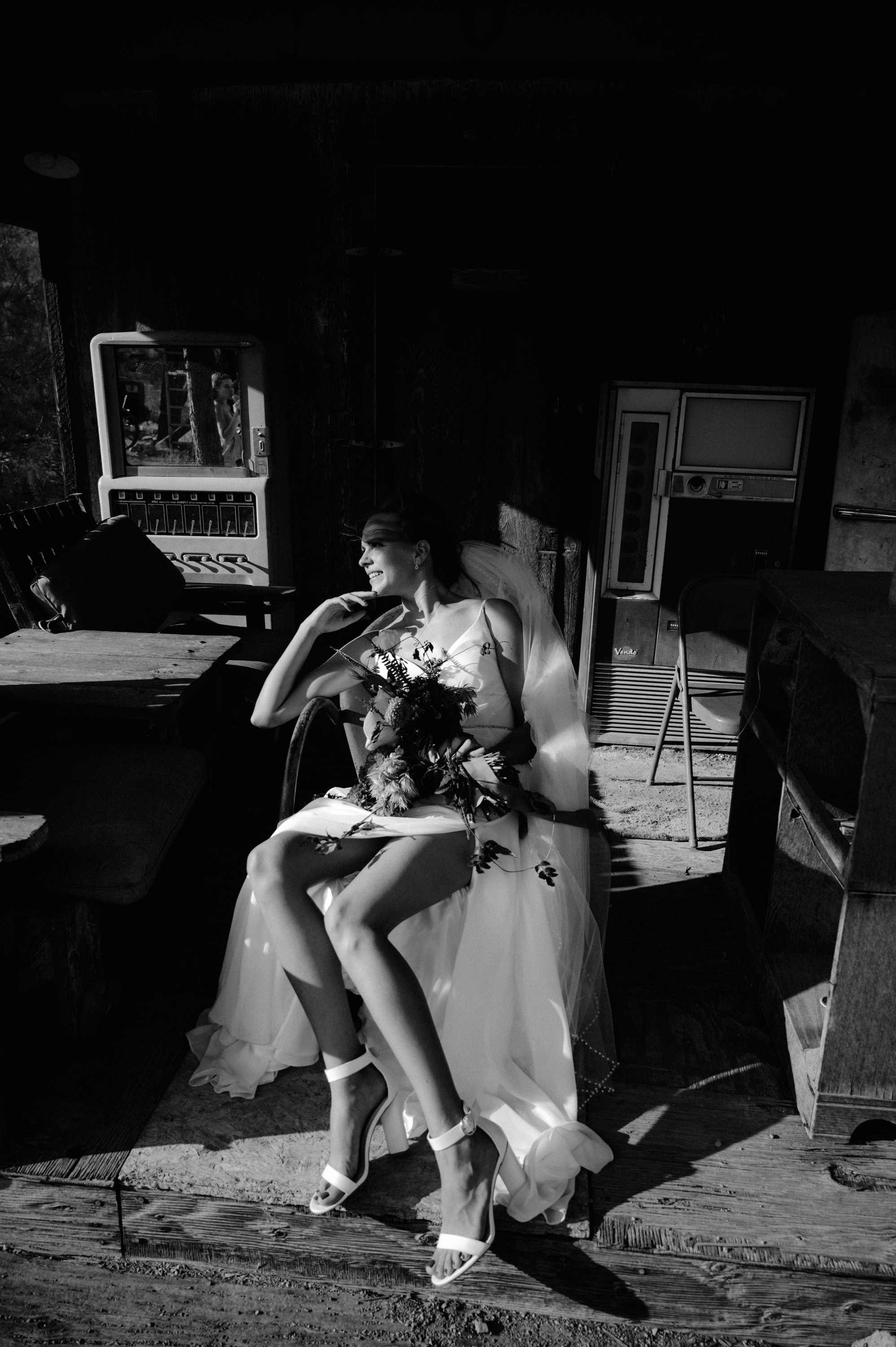 a woman in a wedding dress sitting on a chair