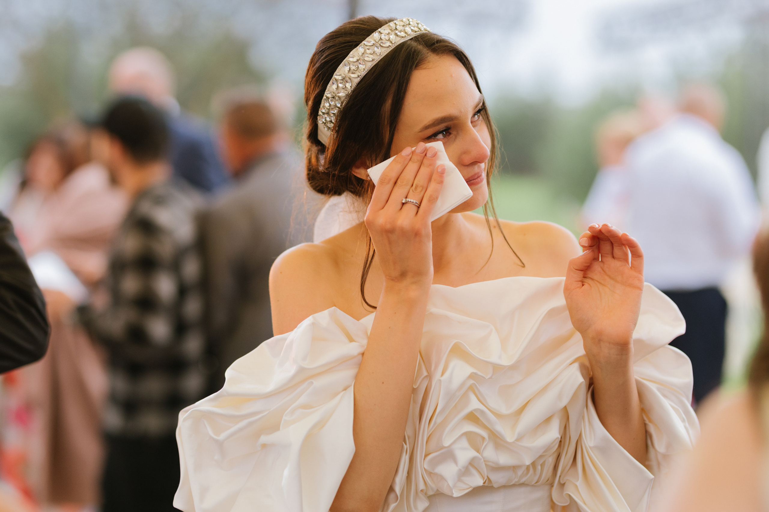 a woman in a white dress is crying