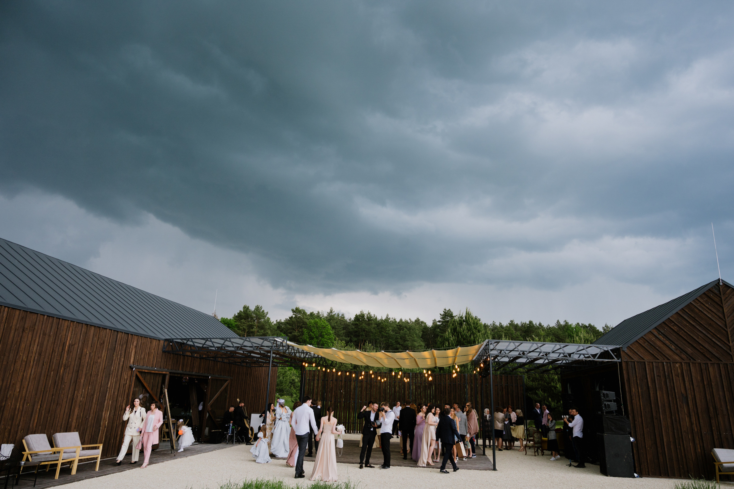 a wedding party outside under a cloudy sky