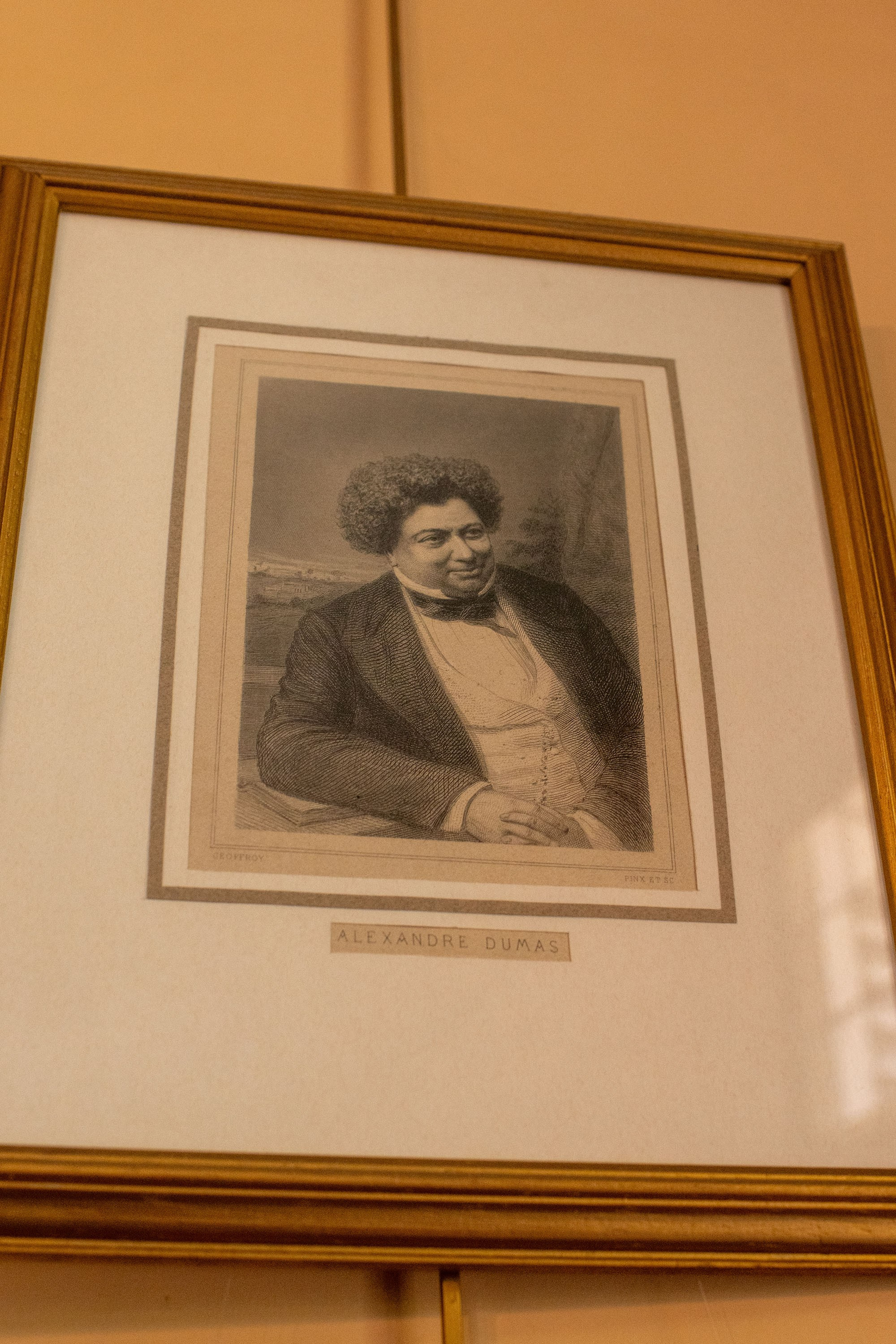 Framed portrait of Alexandre Dumas displayed inside Château de Monte-Cristo museum near Paris