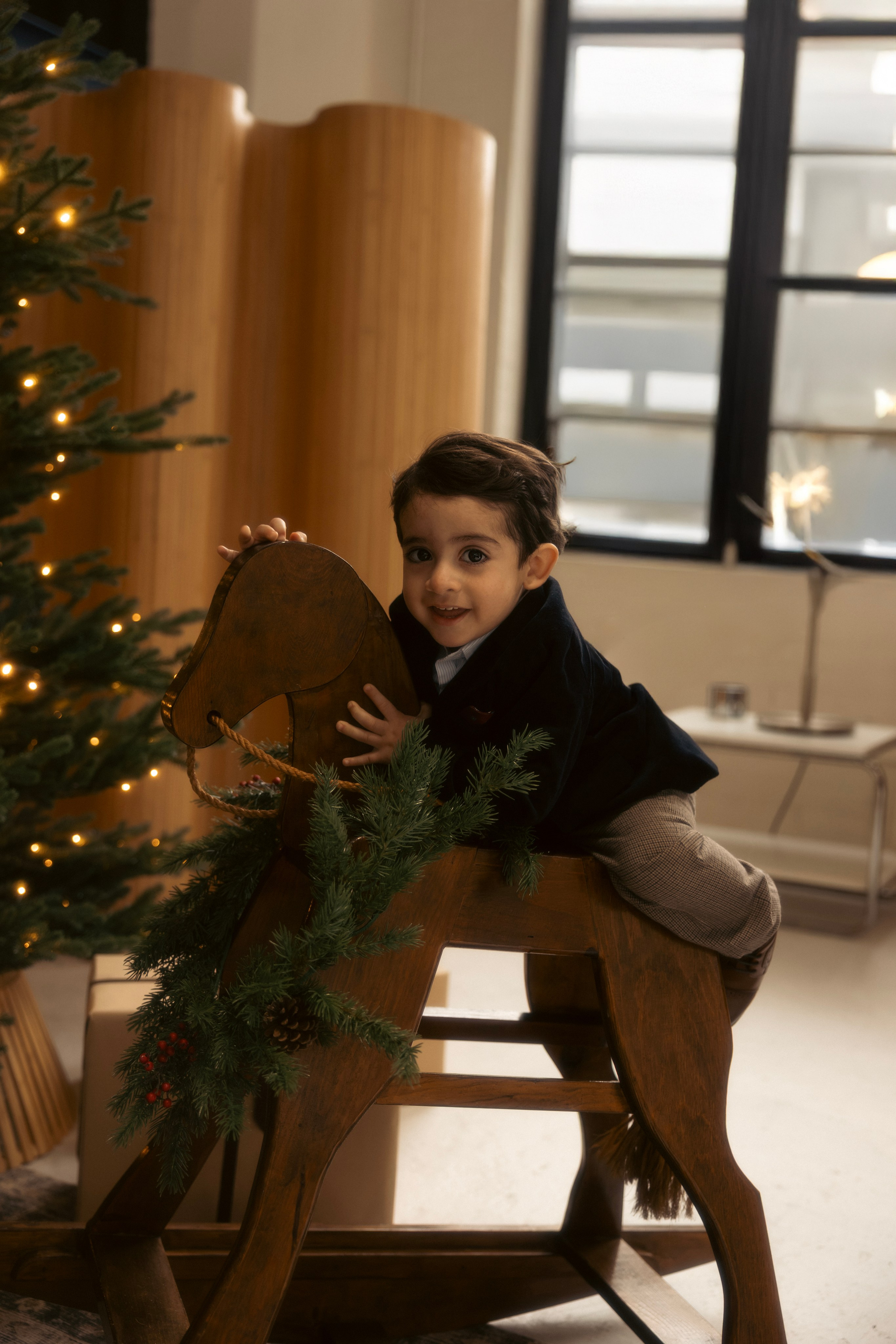 Toddler playing near Christmas tree during mini session in Chicago