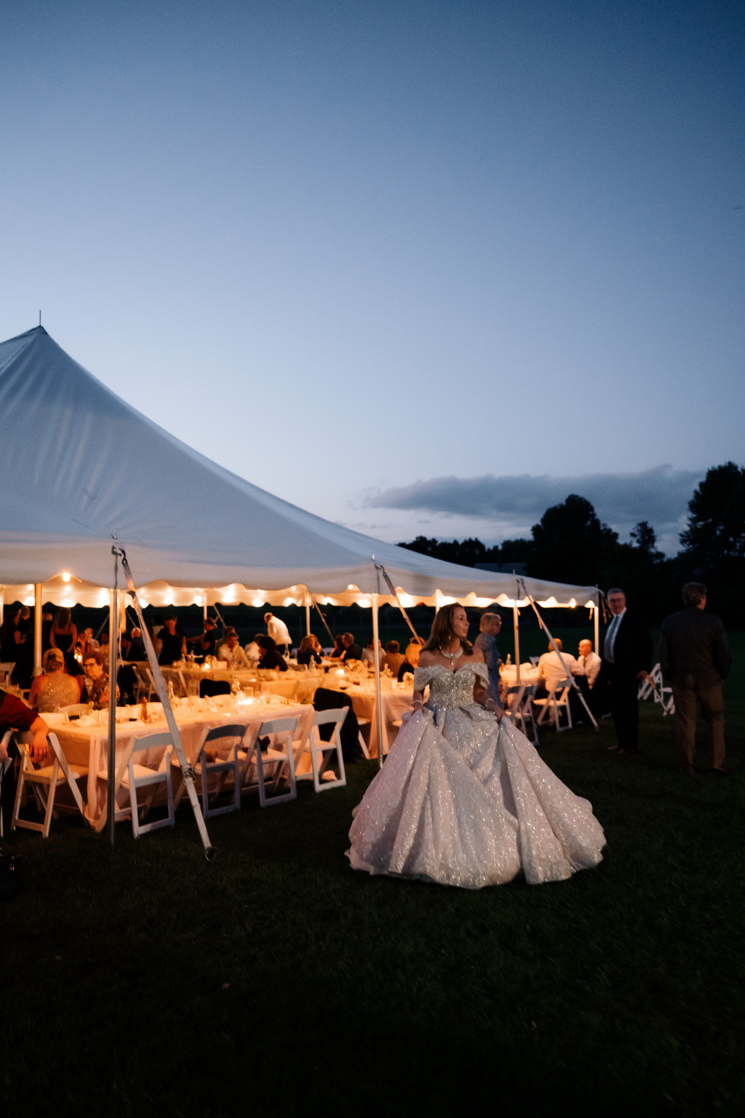 a couple sitting under a tent at night
