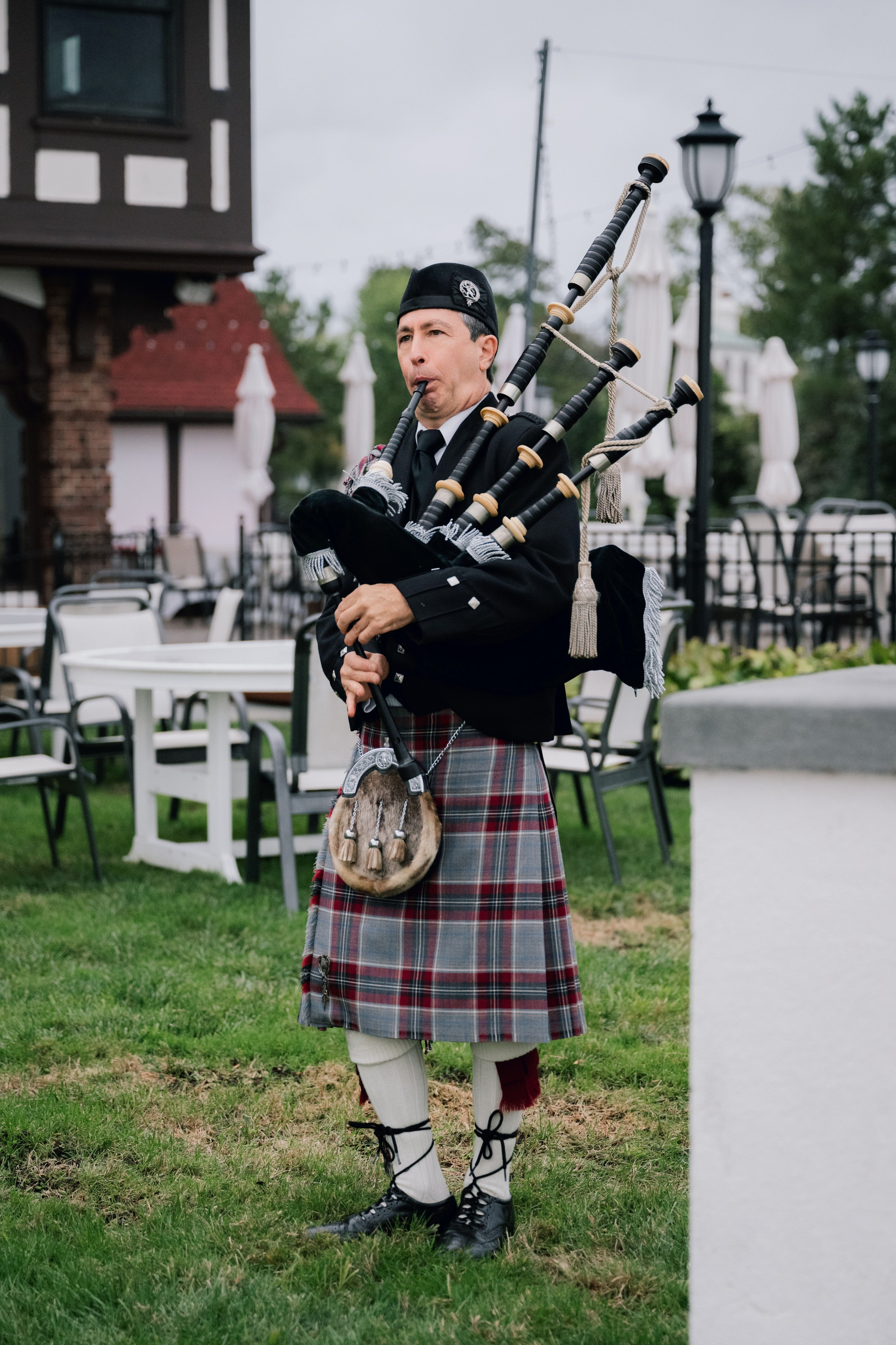 a man in a kilt playing bagpipe