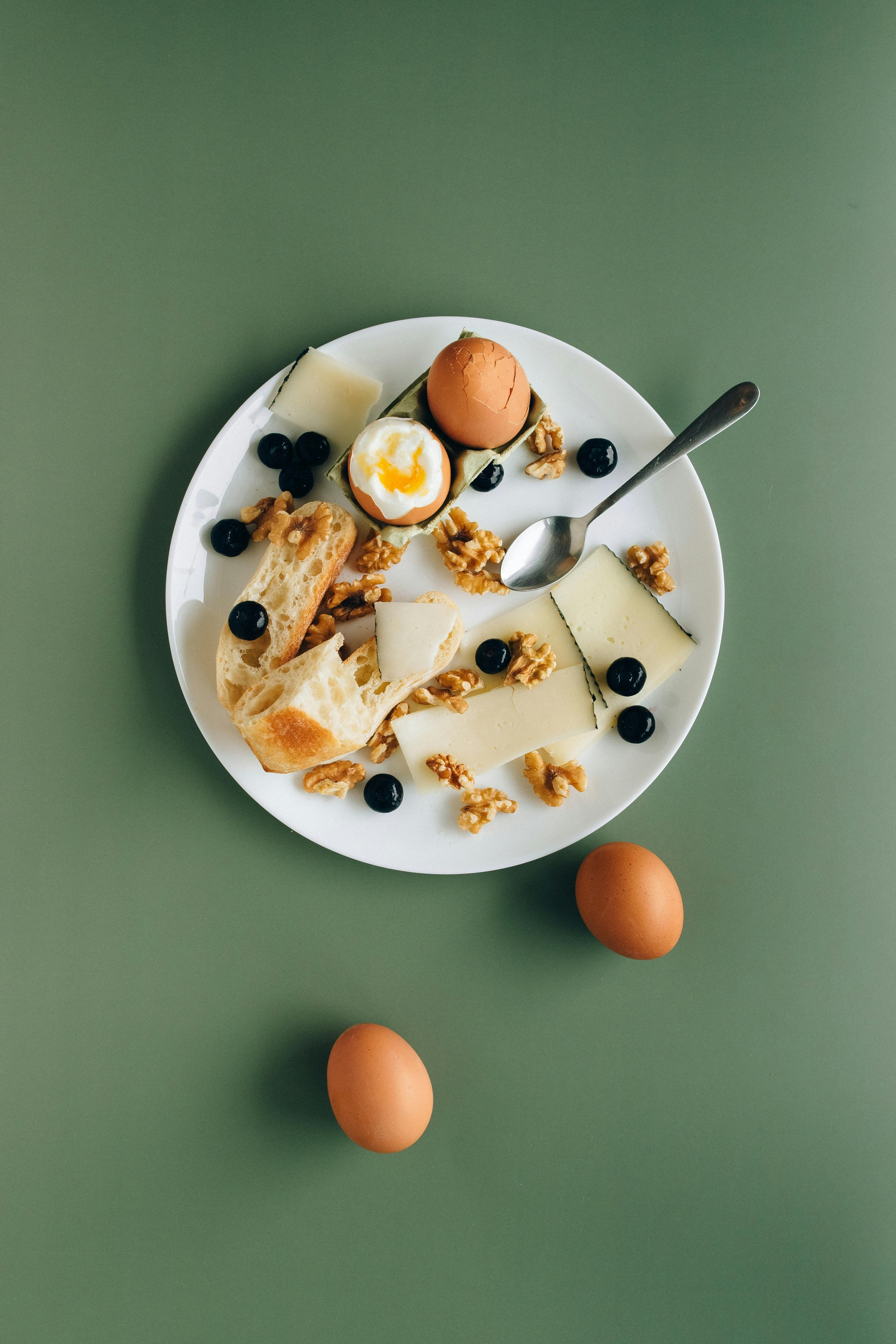 Minimalist breakfast photography featuring cereal bowl and eggs on pastel background, captured by Jay Soundo Creative