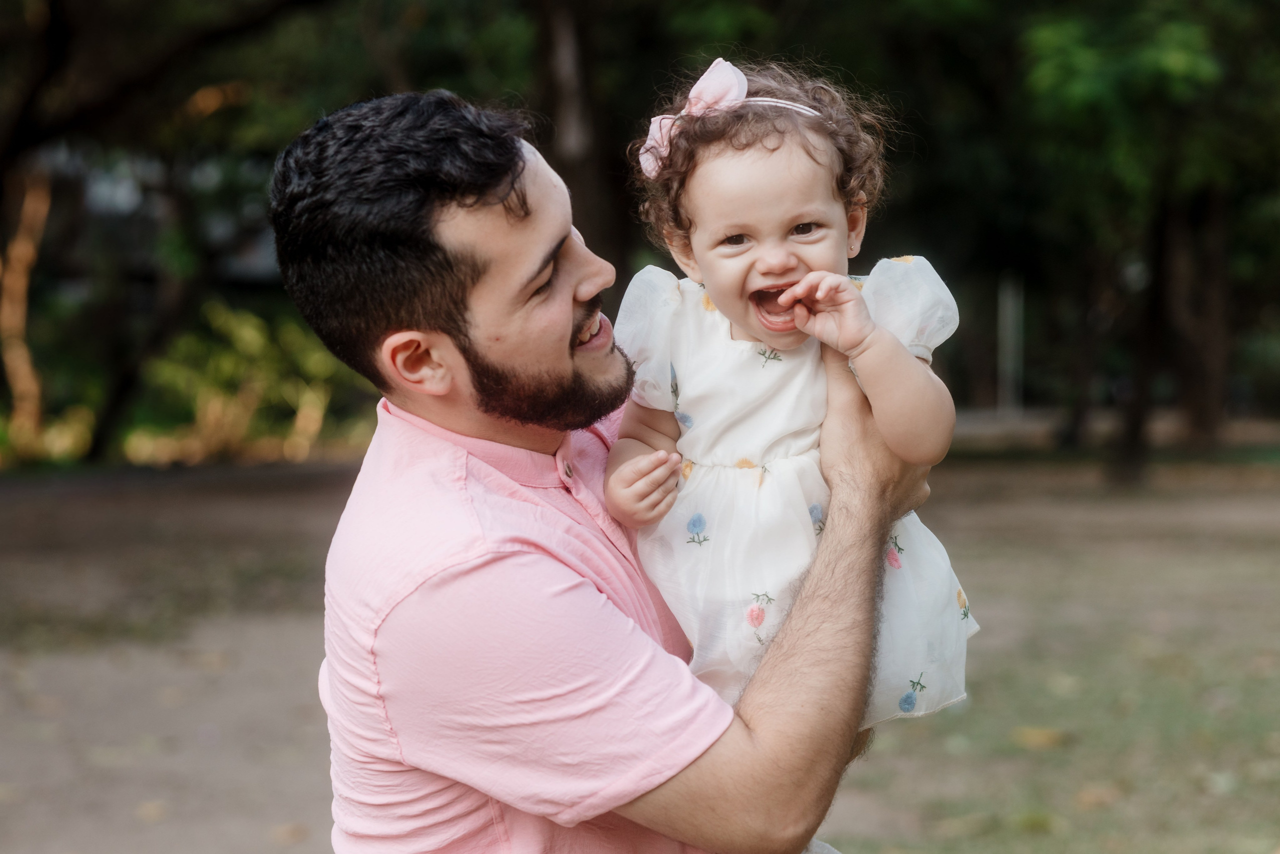 Pai brincando com a filha no ensaio de família