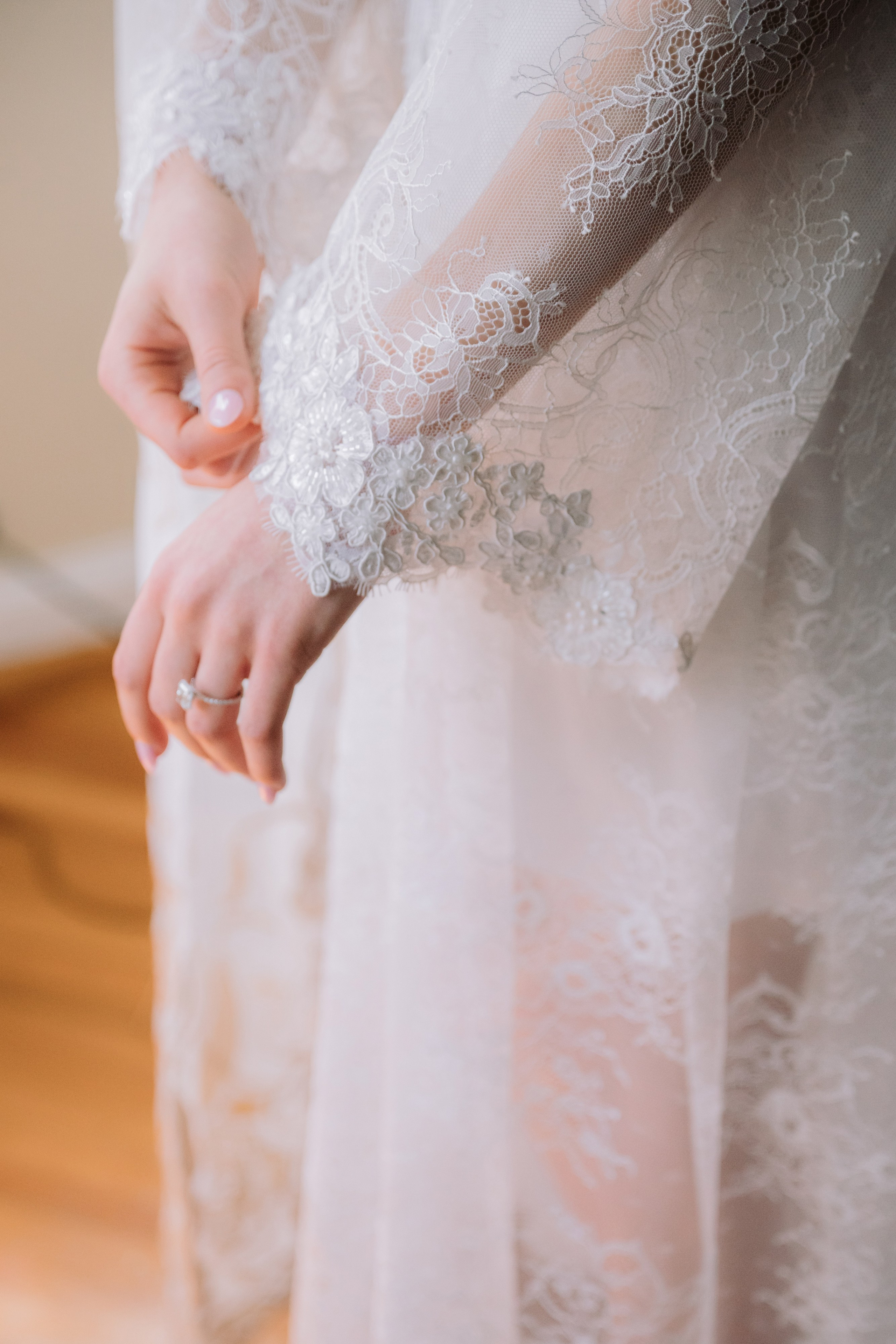 a woman in a white dress holding a ring