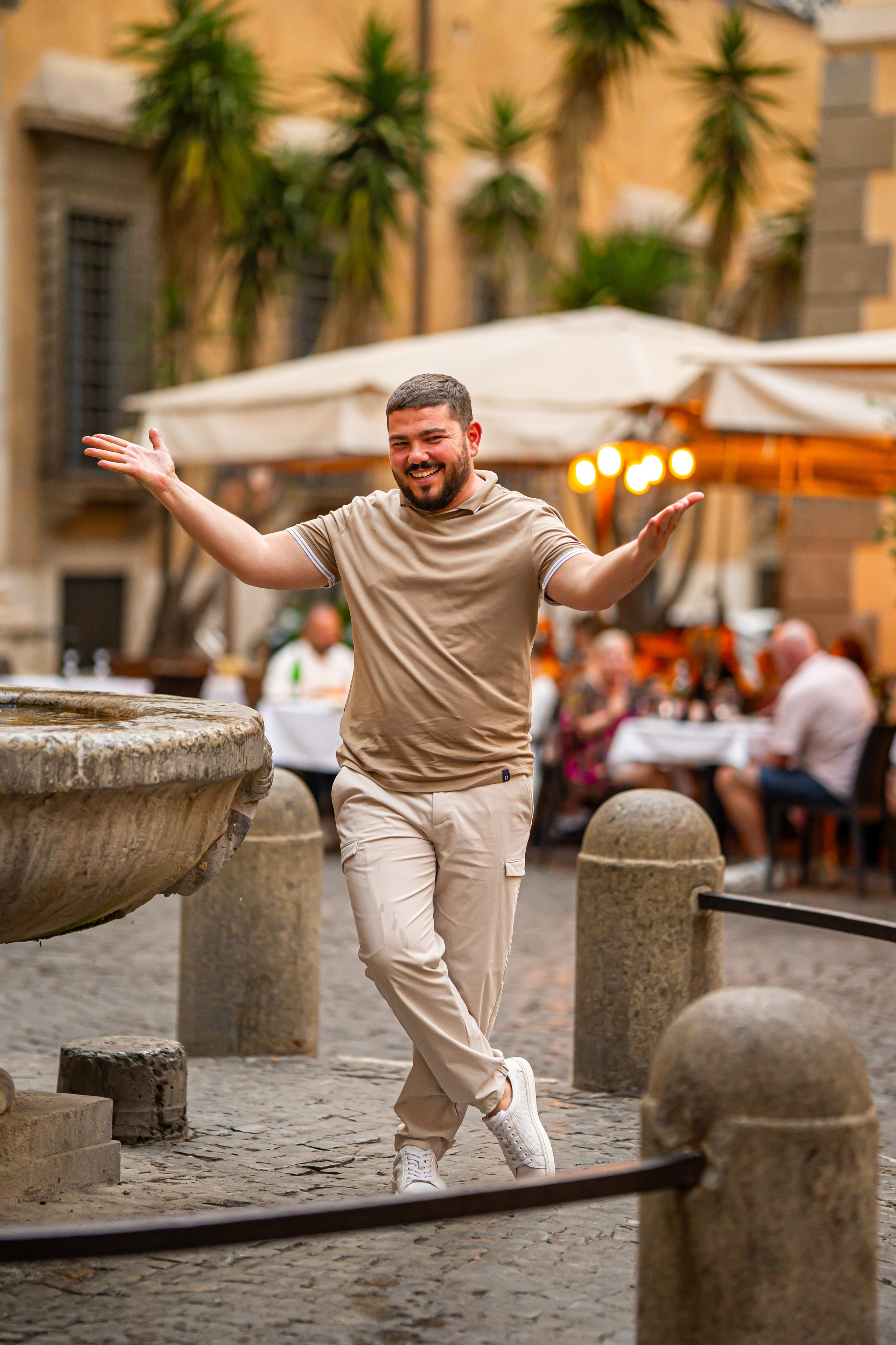 Man in a Roman square by a café — beautiful photo shoot in Rome