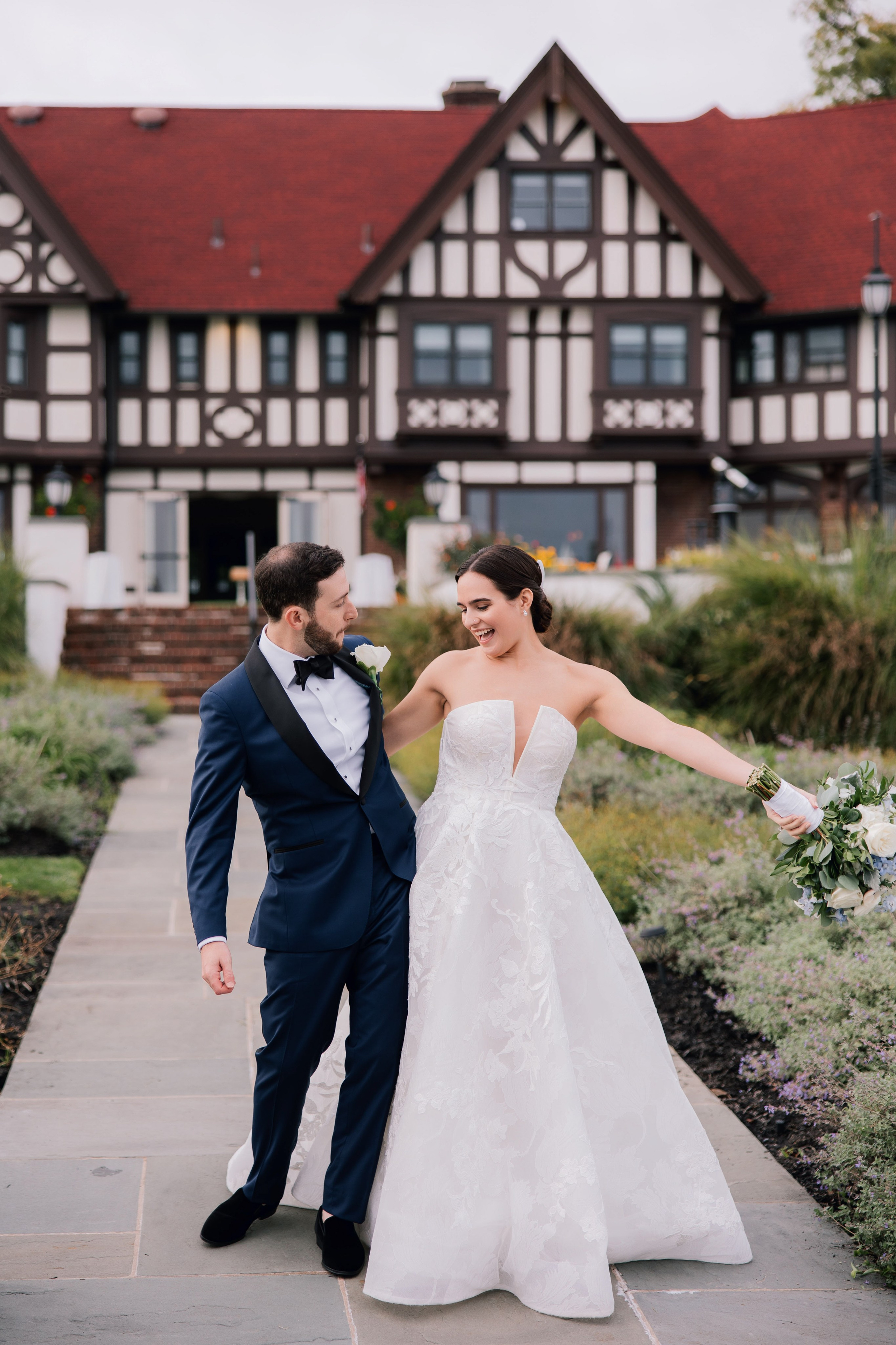 a bride and groom walking down a sidewalk