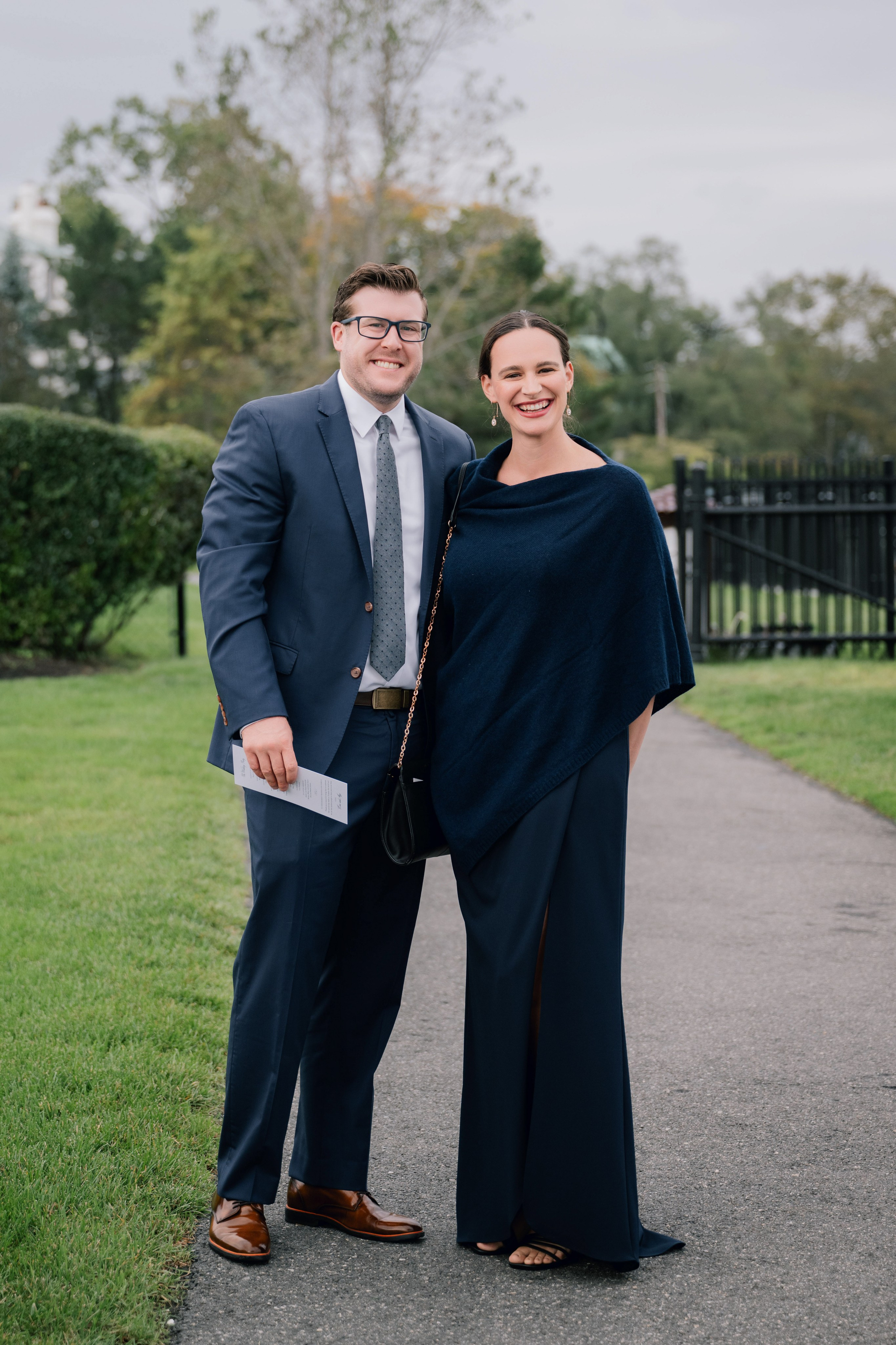a man and woman standing on a path