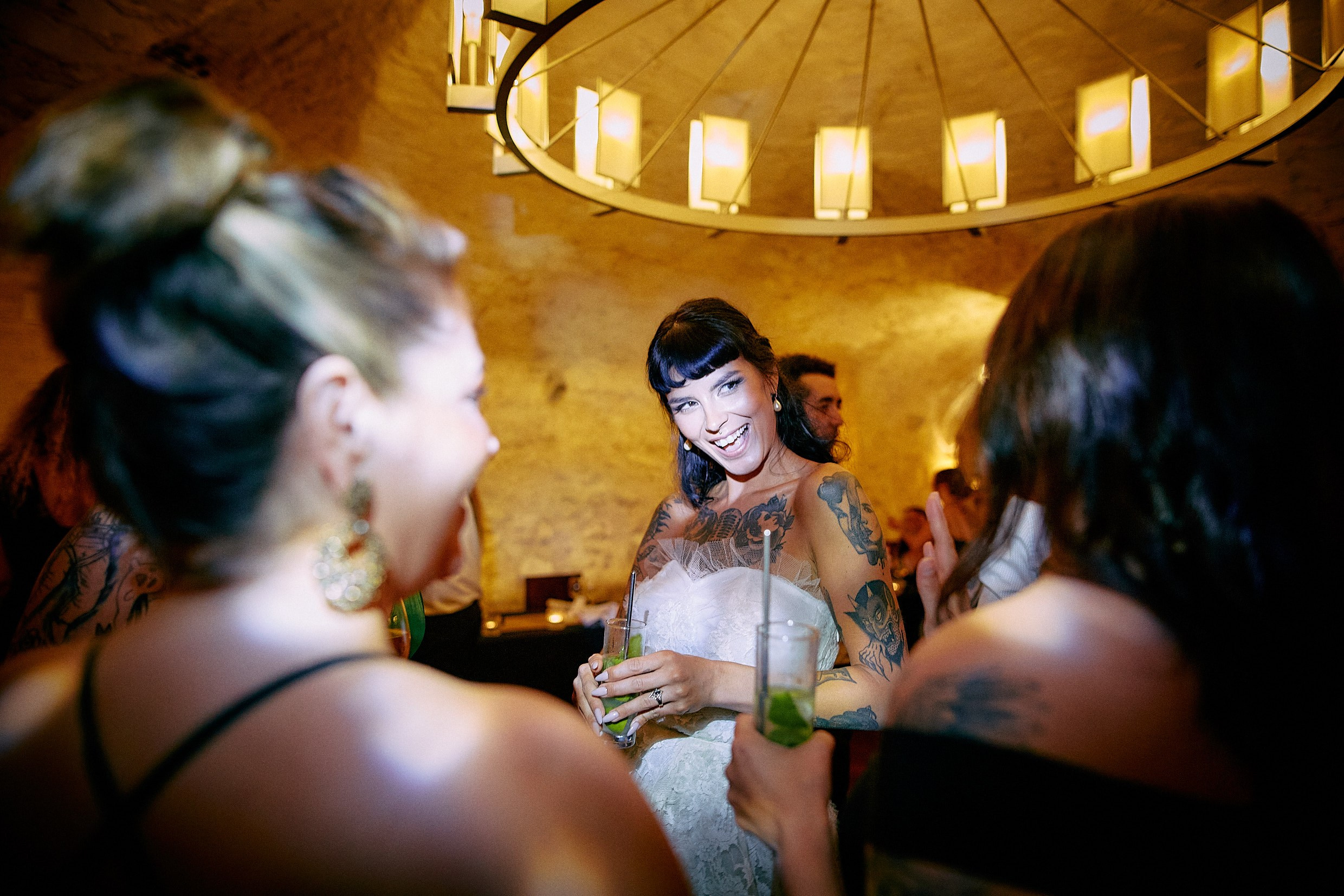 Wedding guests soaking up lively brewery bar party atmosphere.