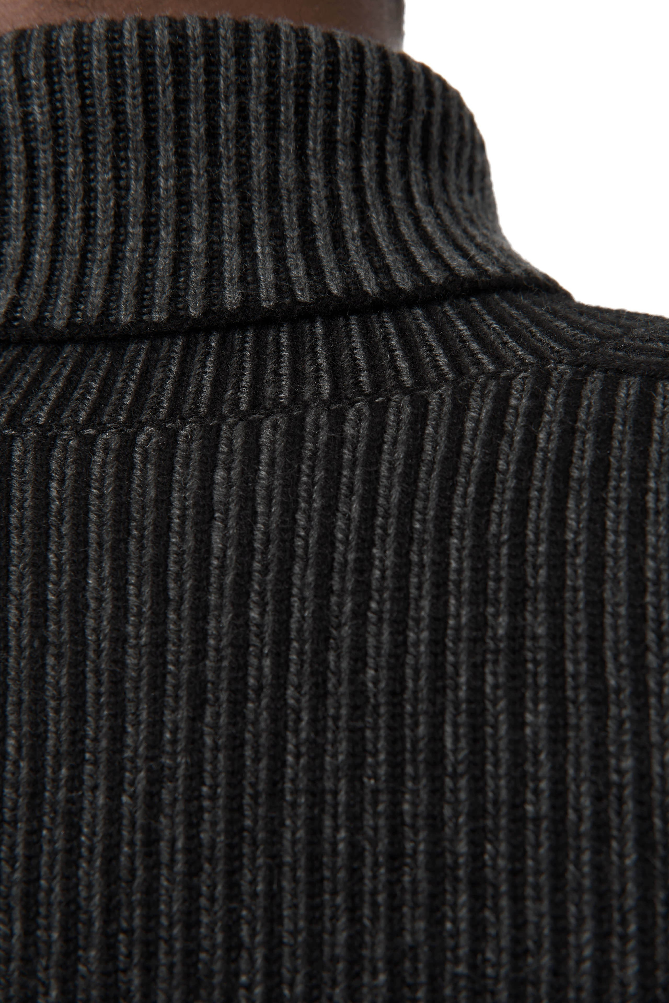Detailaufnahme – Kragen und Struktur des schwarzen Rollkragenpullovers.