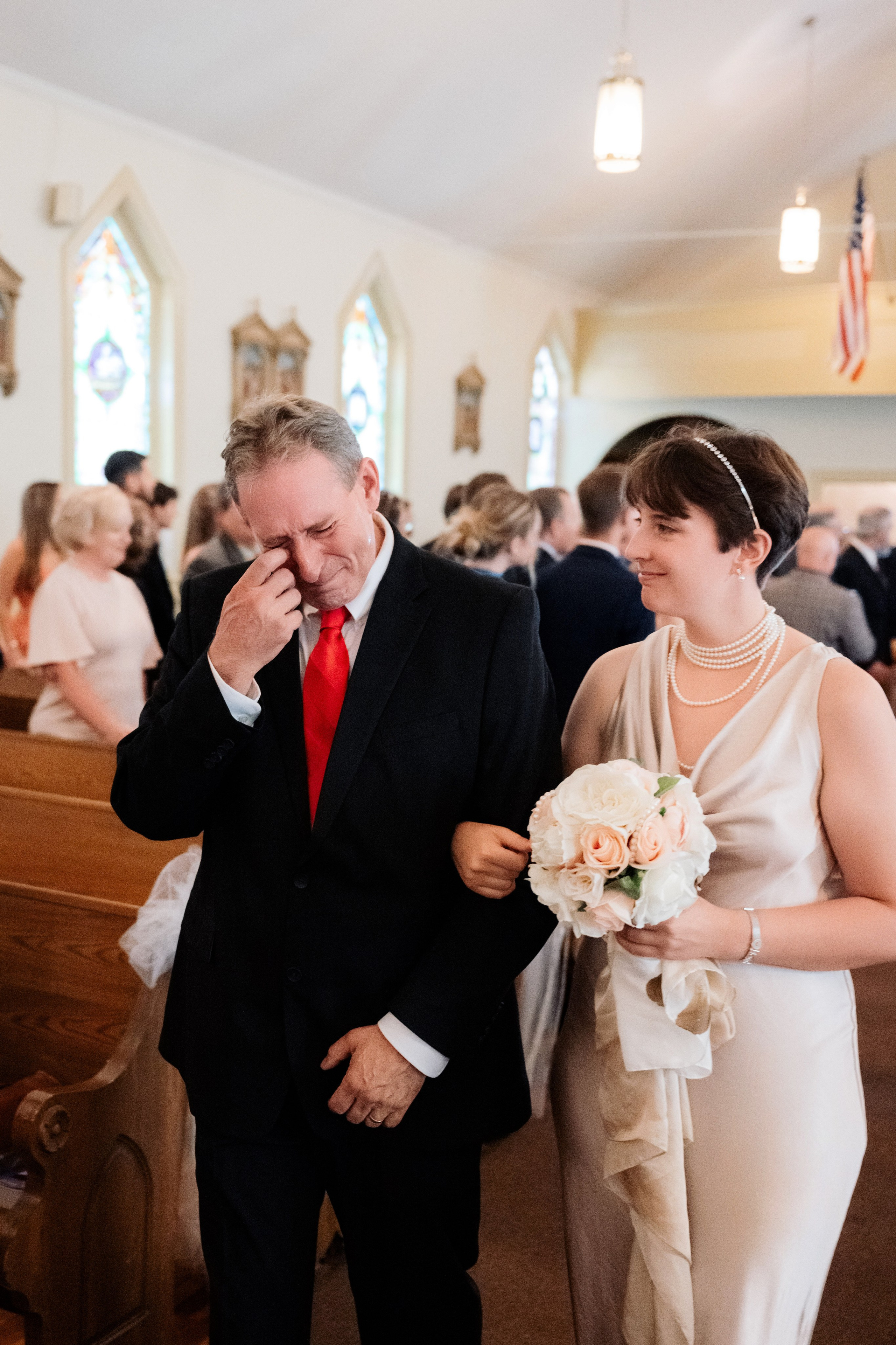 a man and woman walking down the aisle