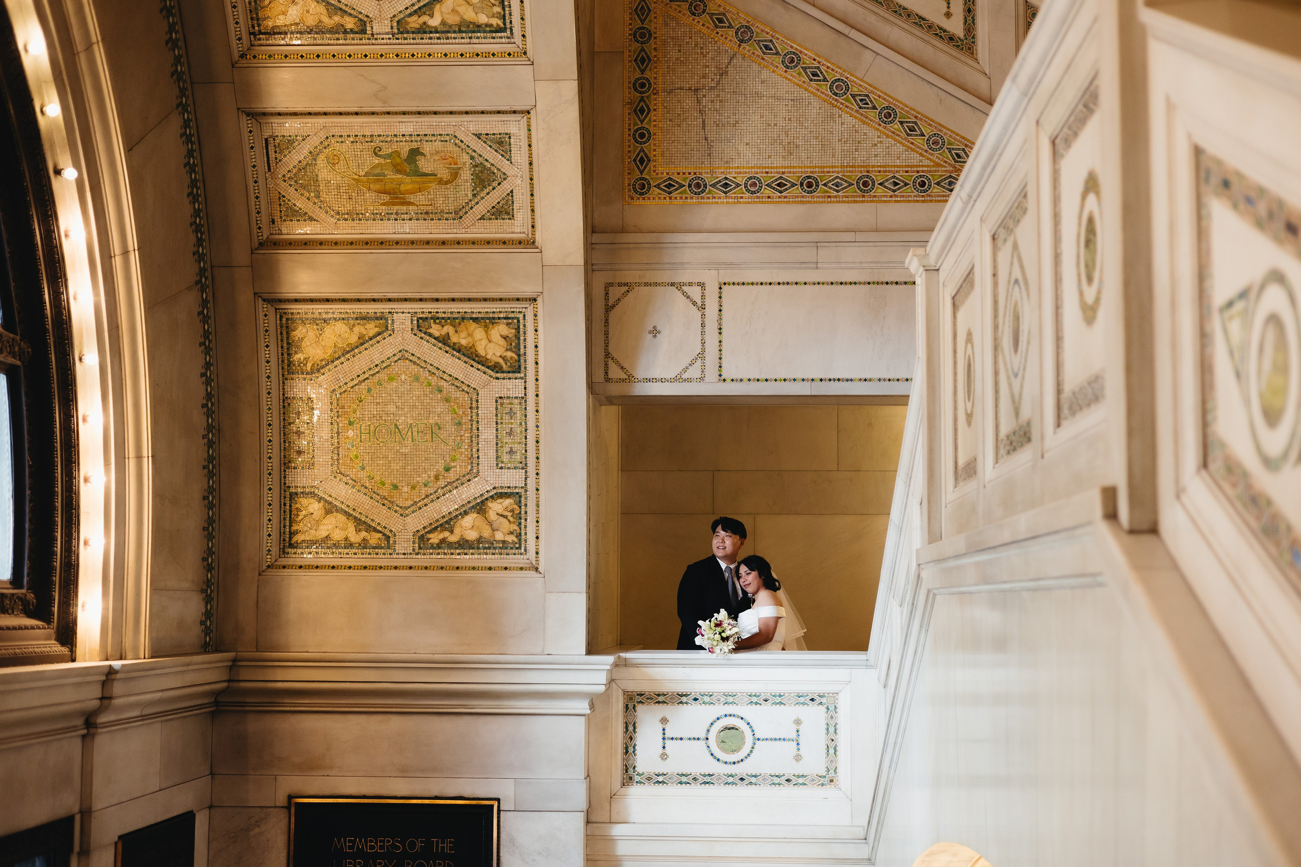 Wide shot of couple kissing inside the Chicago Cultural Center