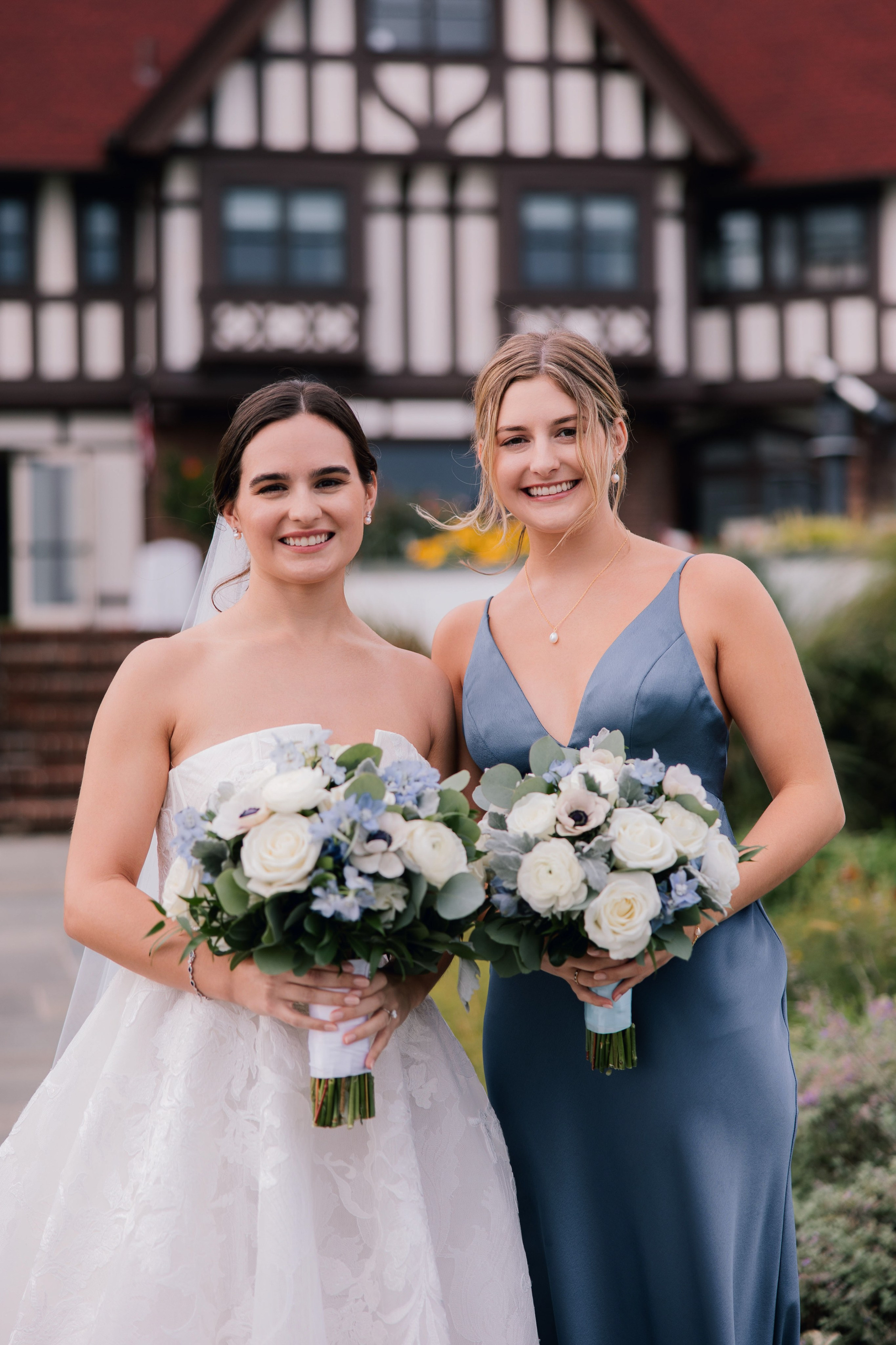 two brides in blue dresses holding bouquets