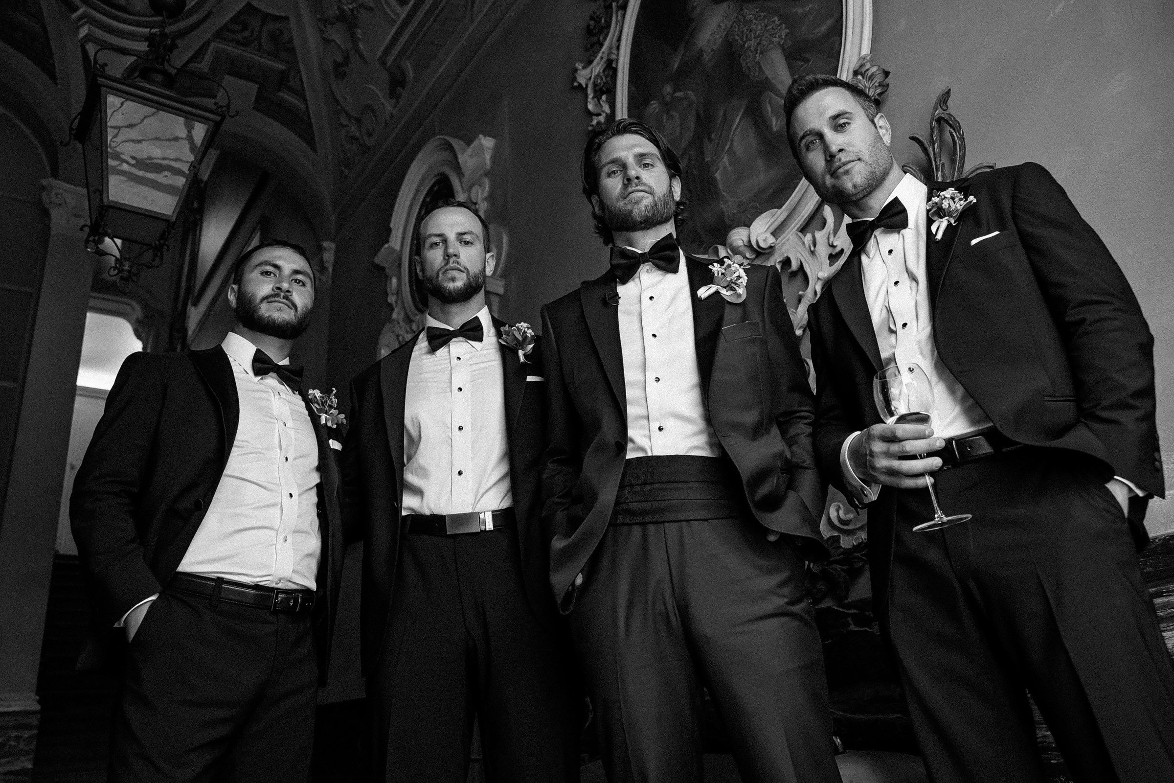 Groomsmen wearing classic tuxedos gather for a photo, highlighting their sophisticated appearance and friendship.