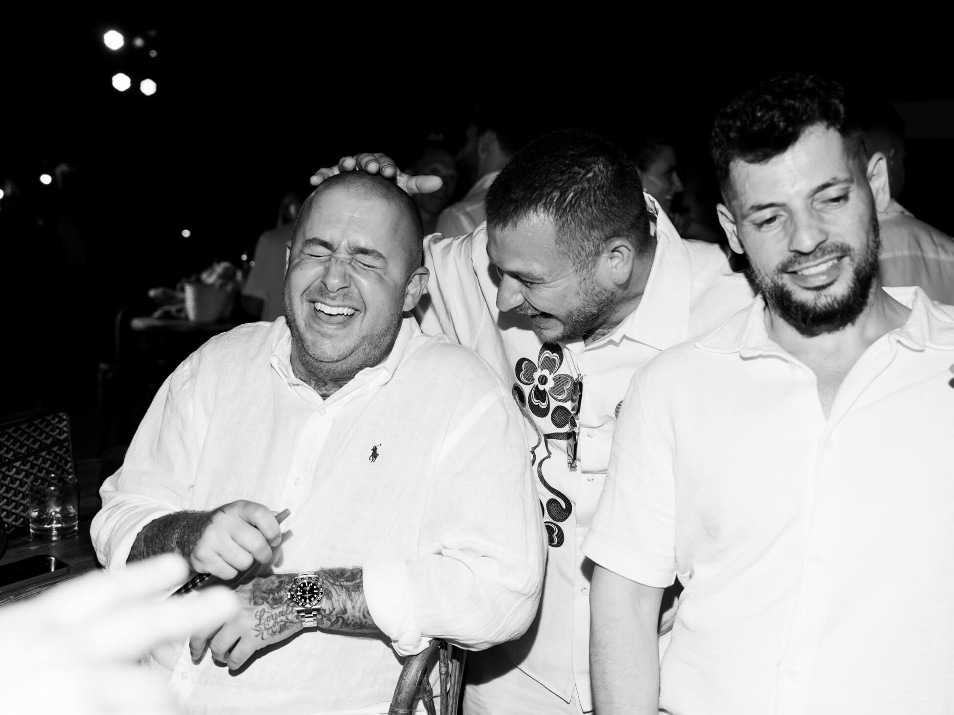 Black and white photo of guests laughing together