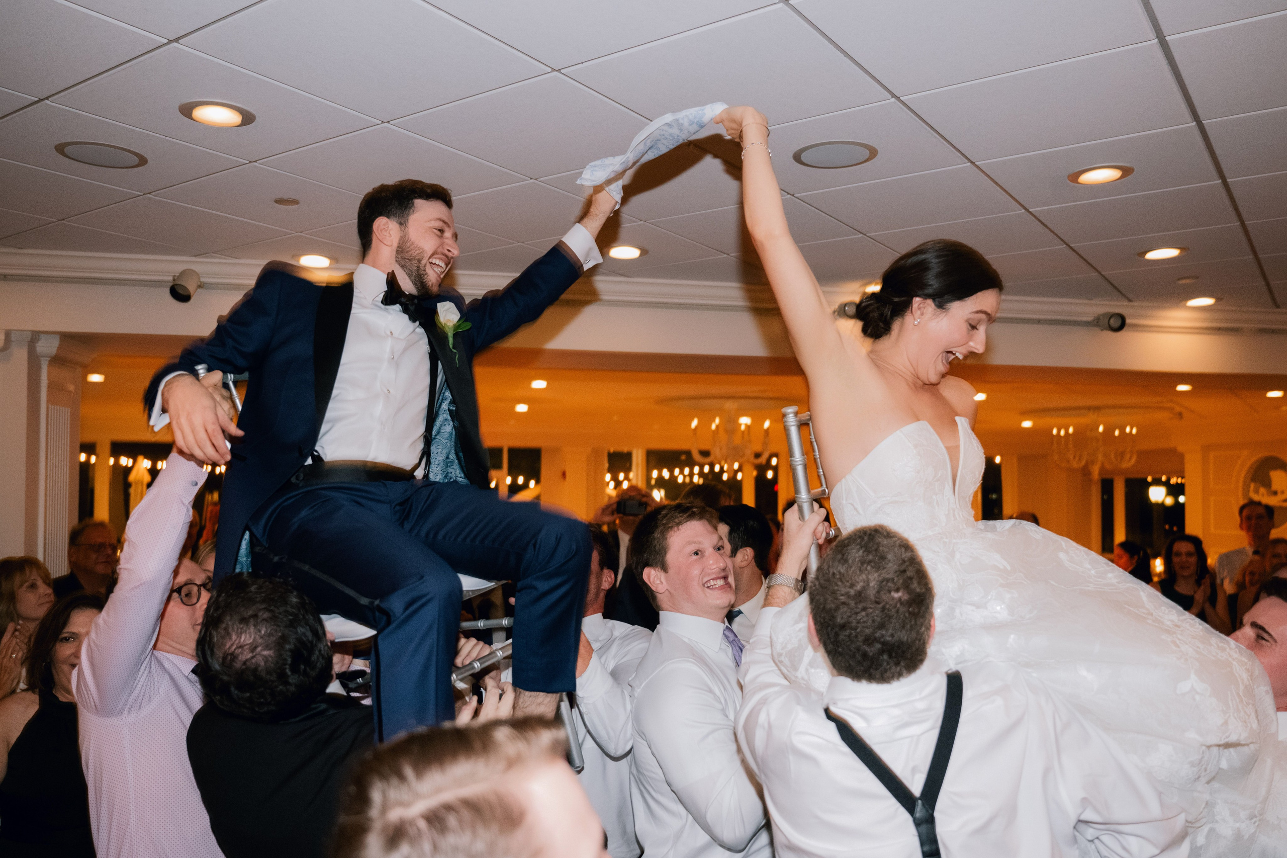 a bride and groom are jumping in the air