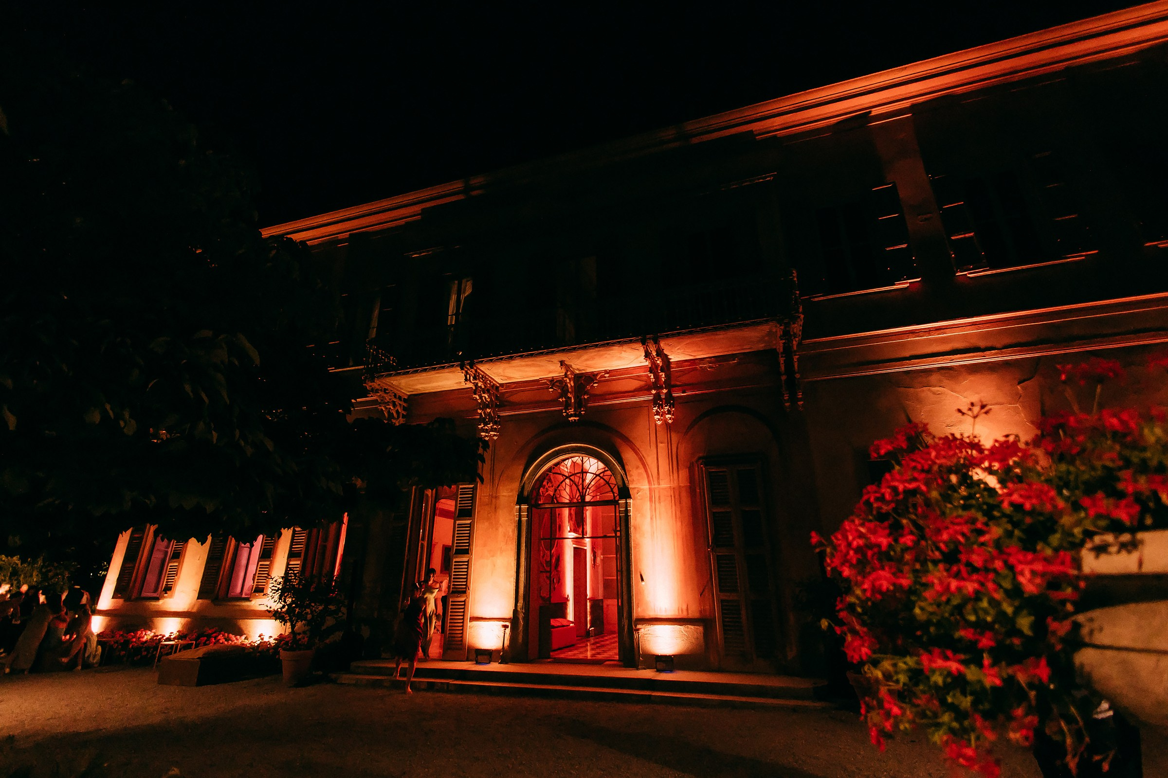 Grand venue exterior of Villa Pizzo warmly illuminated at night, creating an inviting and elegant atmosphere.