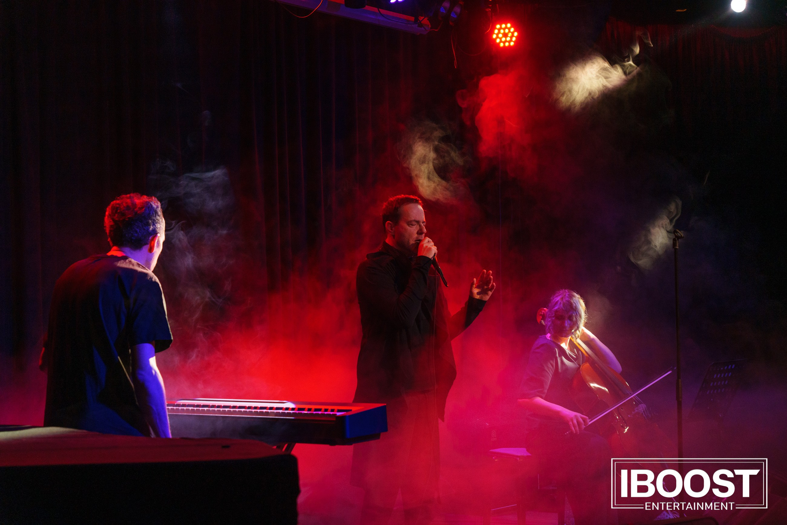 Wide stage view of Animal JazZ performing in Sofia, with vocalist Krasovitsky and keyboardist in red concert lighting.