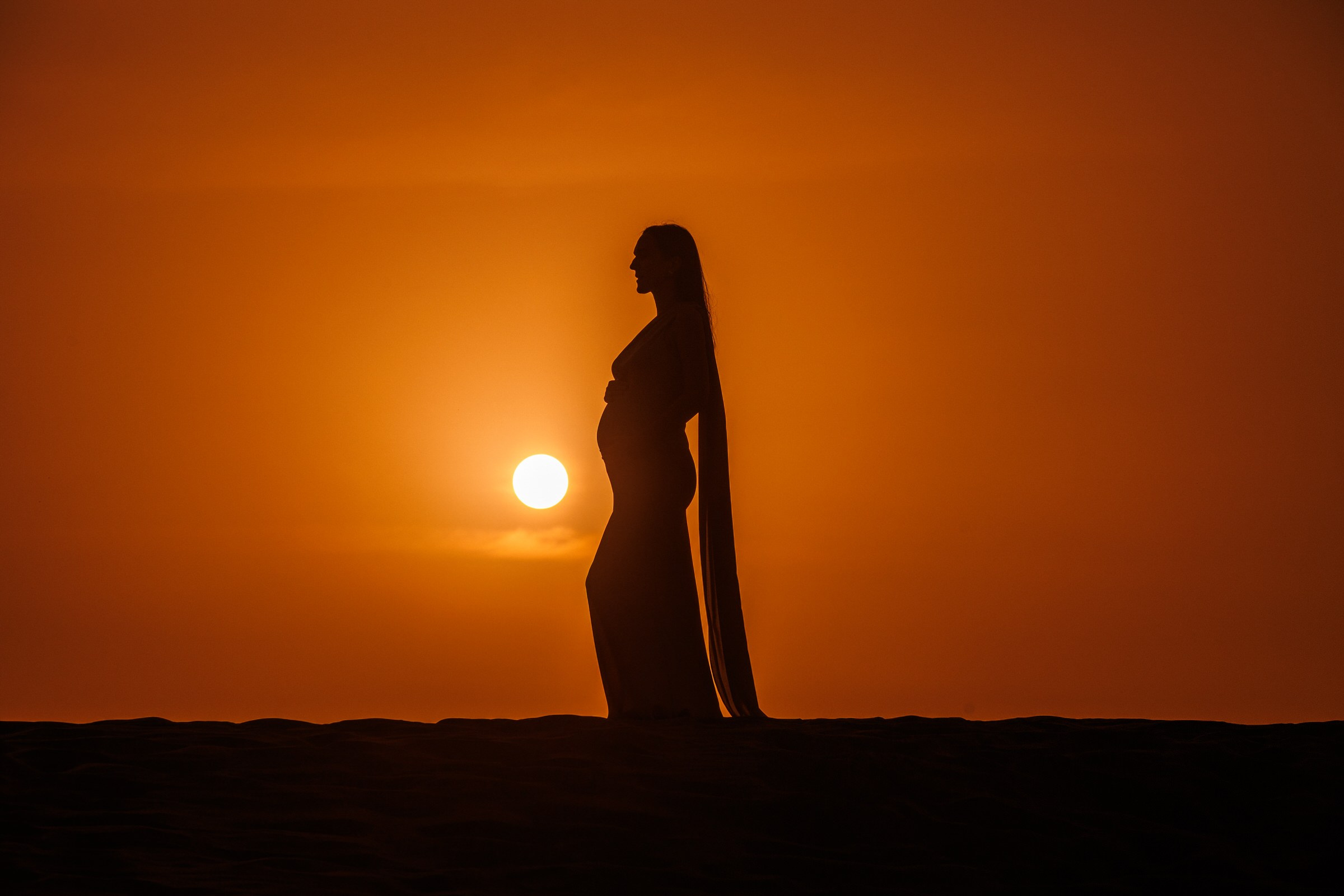 Pregnant woman silhouette in maternity photoshoot at sunset in Maspalomas dunes gran canaria