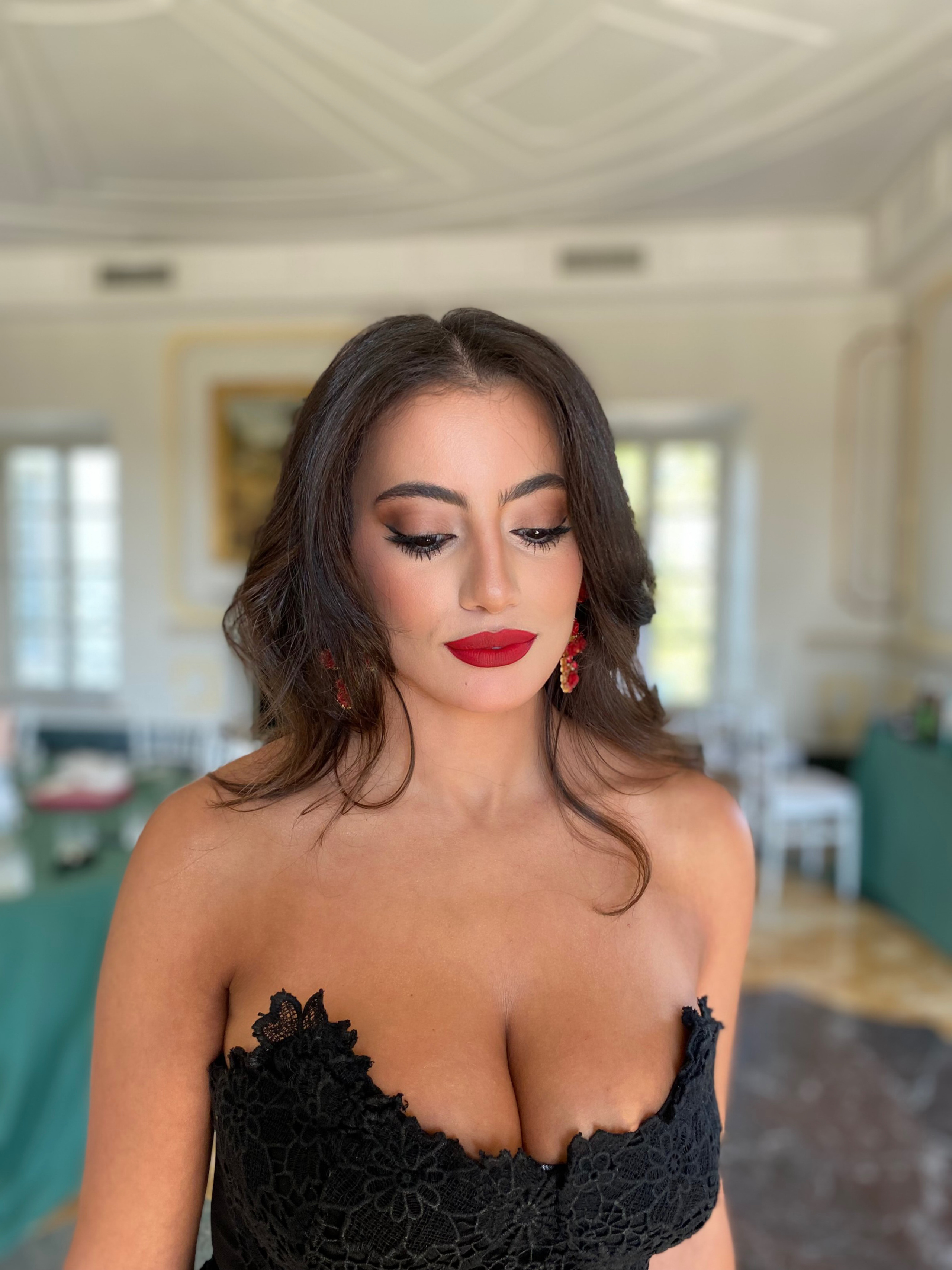 red lips and blended dark smoky eye makeup on a woman from Arabic country-Rome