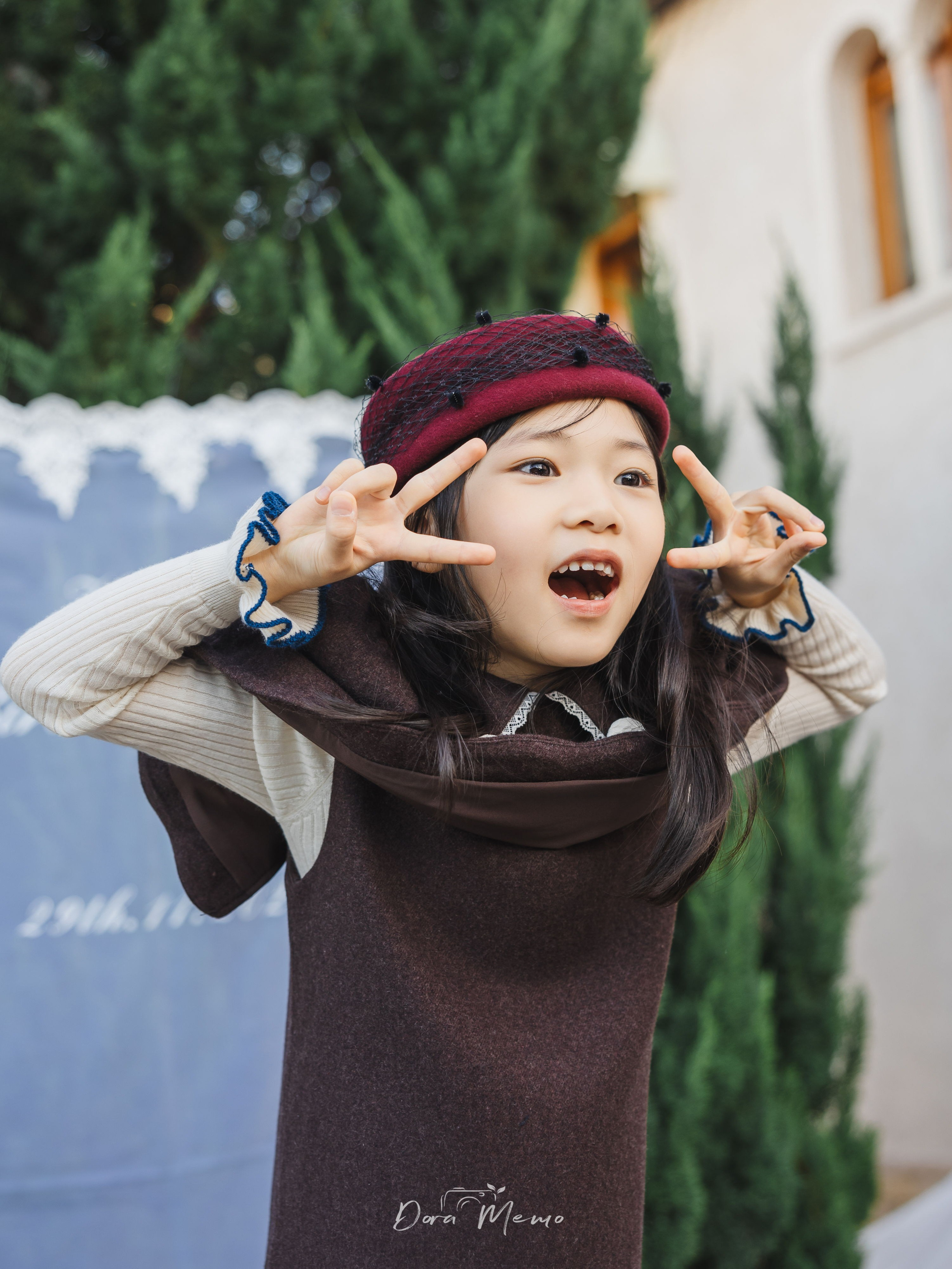 Shanghai family photographer - close-up of girl making playful V sign, candid expression