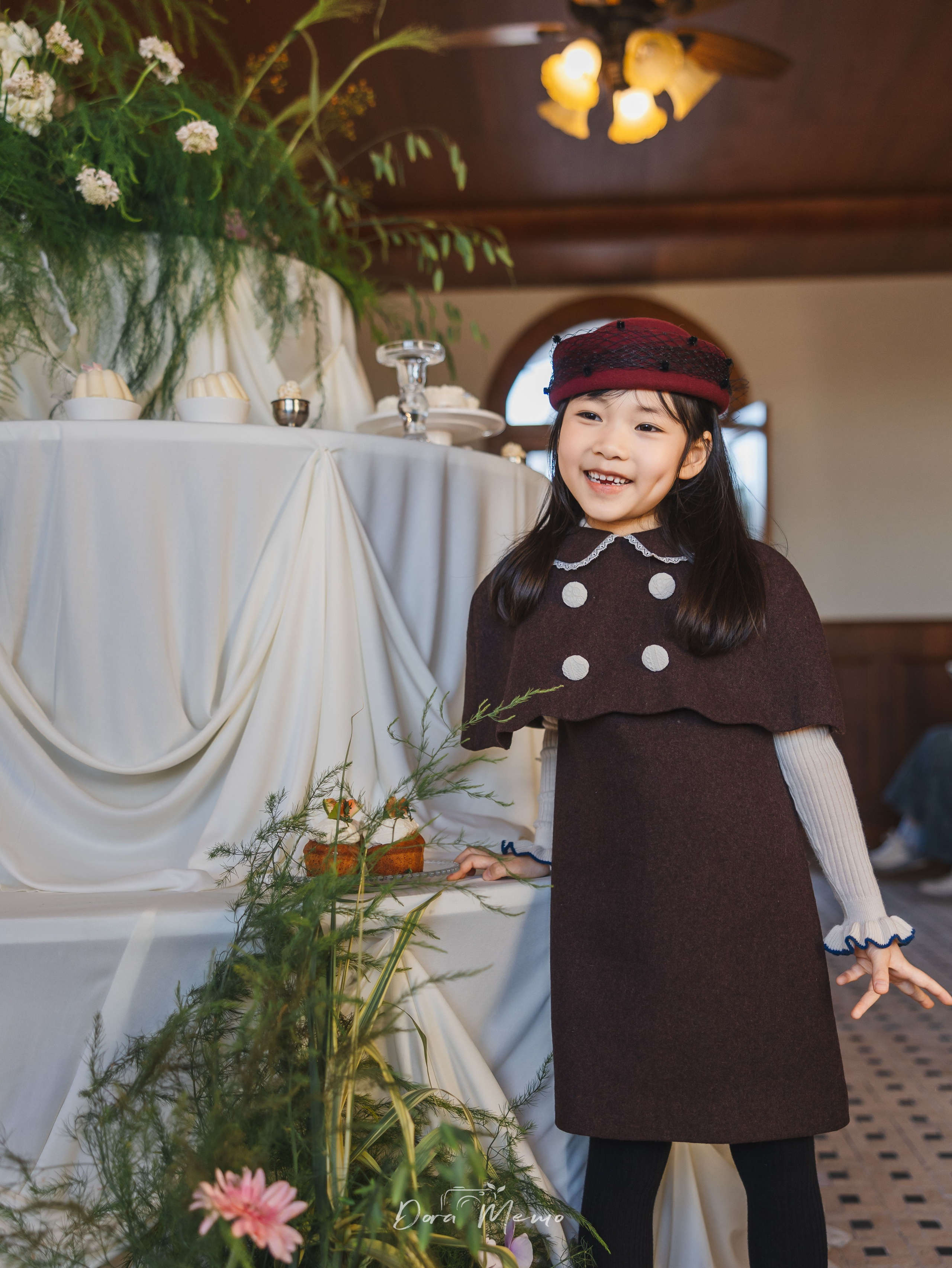 Girl smiling with hands touching hair, emotional portrait at birthday party, soft natural light