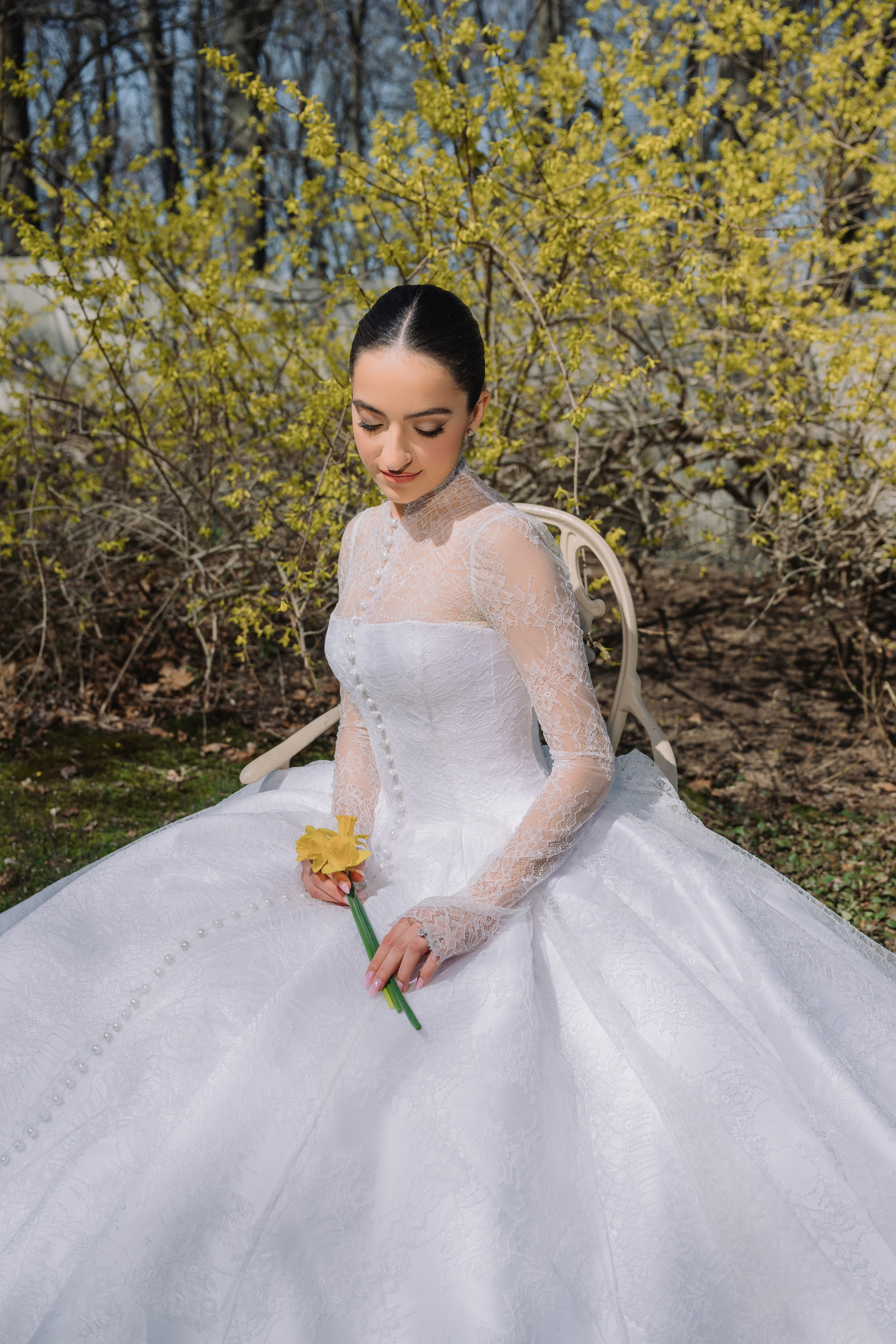 a woman in a white wedding dress sitting on the ground