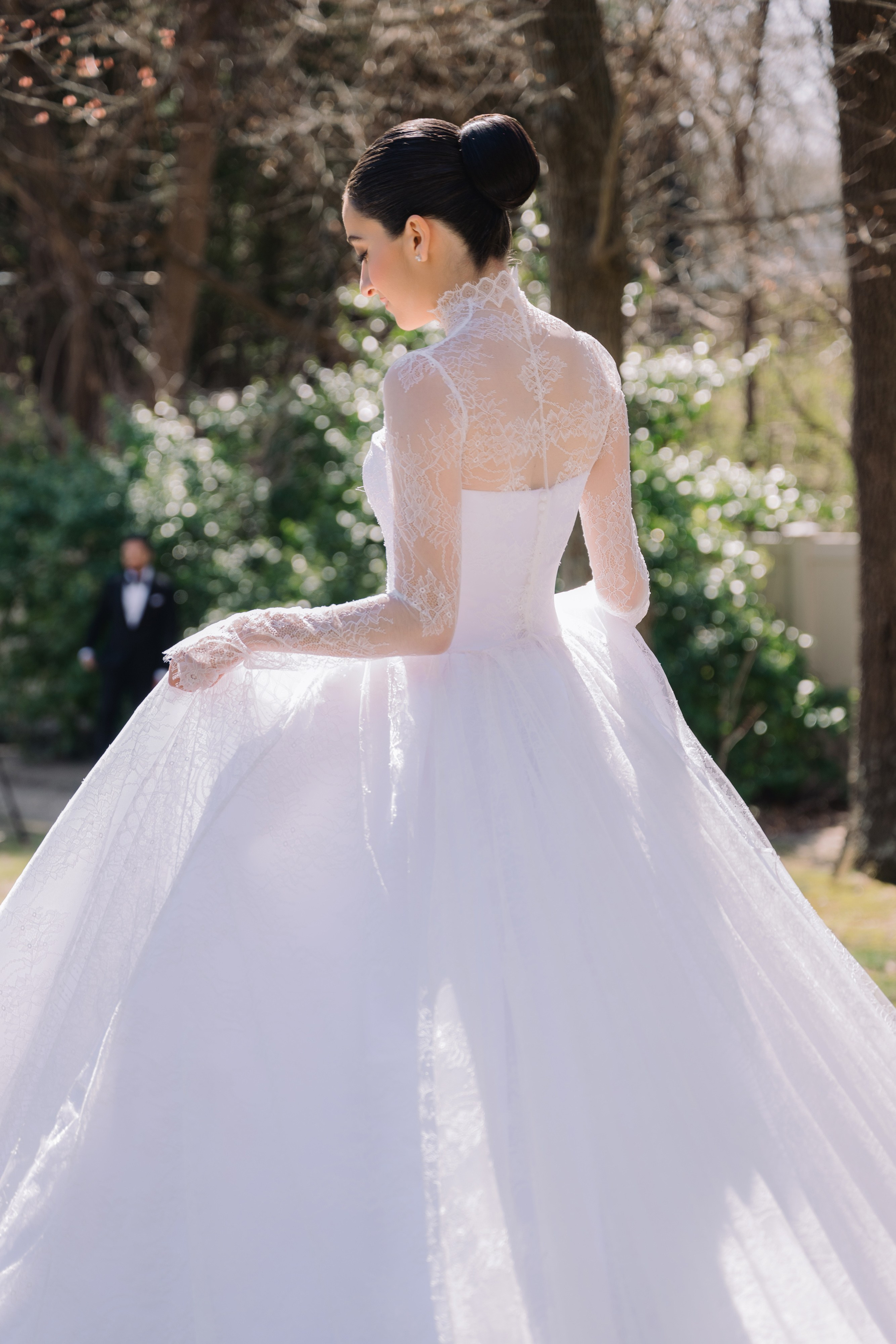 a woman in a white wedding dress standing in the grass