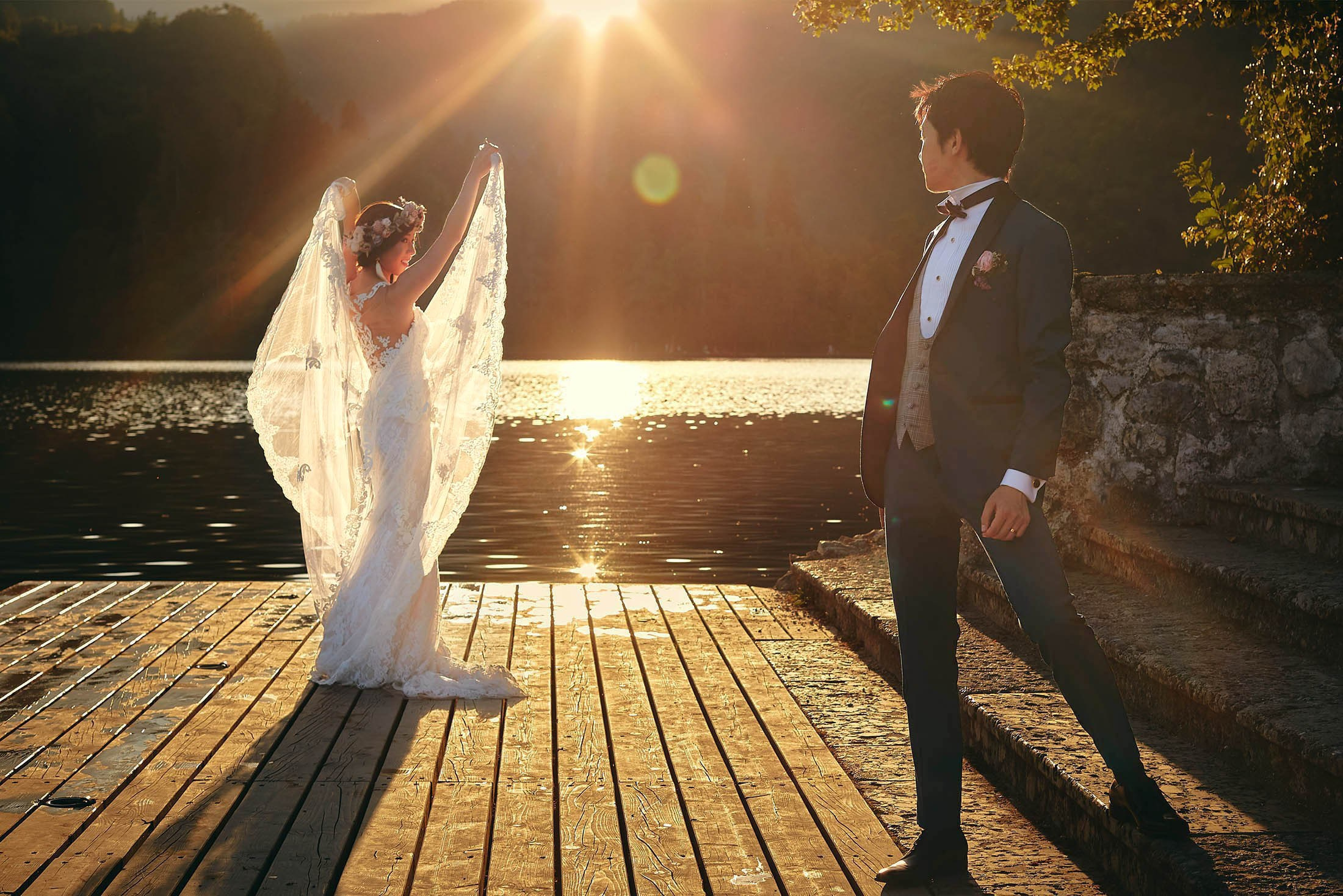 Backlit Japanese bride with veil on Lake Bled, Slovenia, wedding