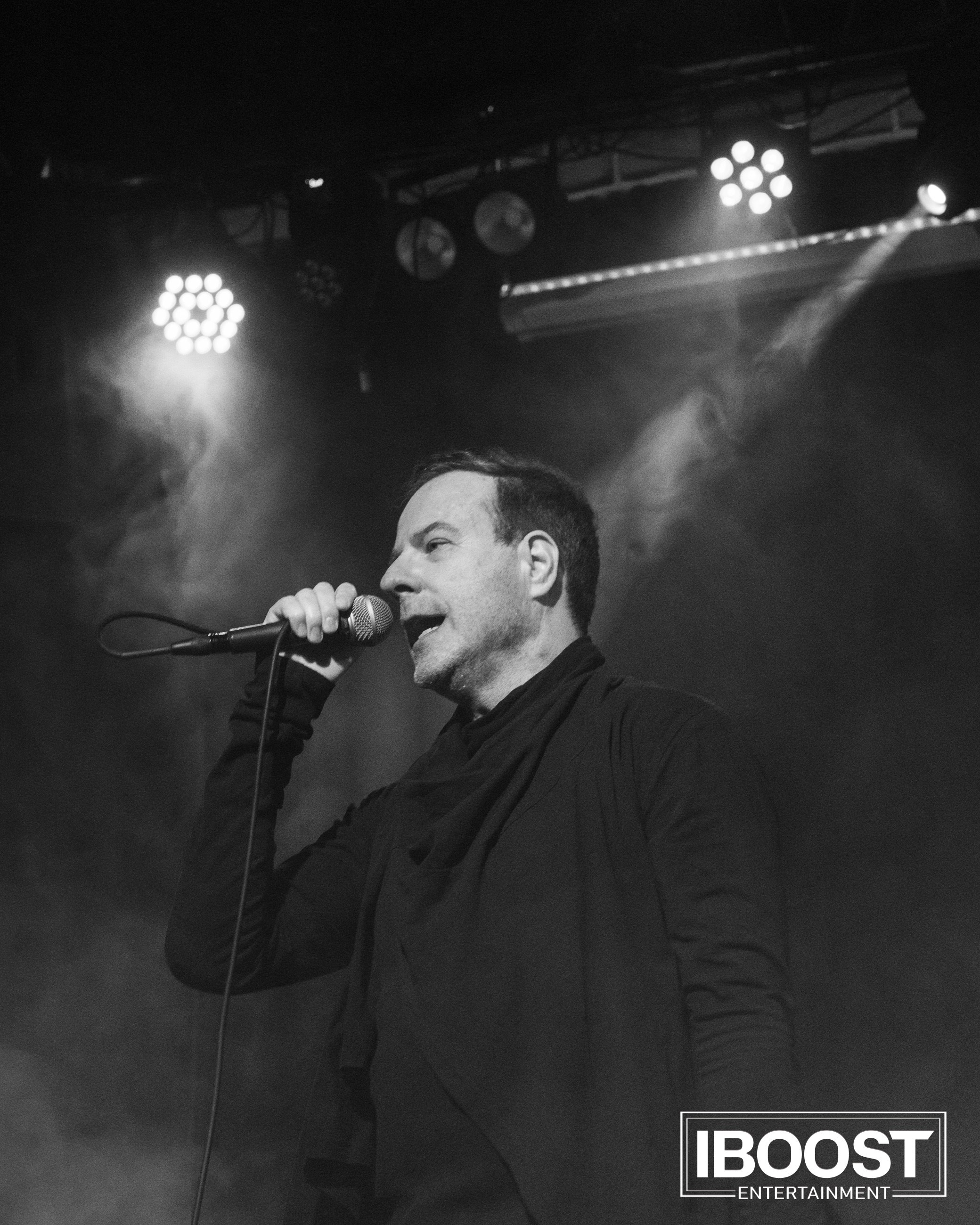 Black-and-white close-up of vocalist Krasovitsky singing under stage lights at the Animal JazZ concert in Sofia.